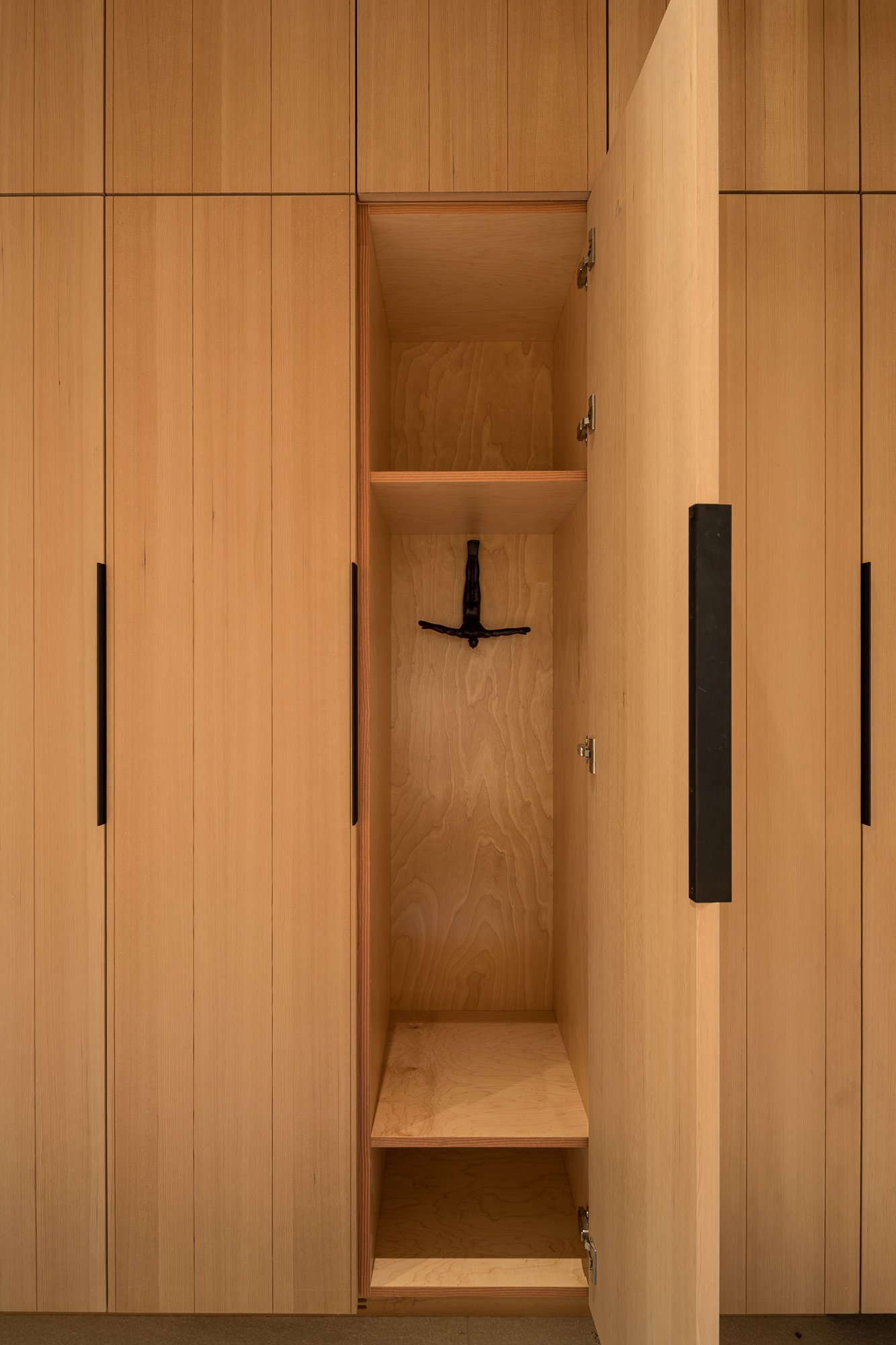 Open wooden cabinet with one empty shelf and one empty base