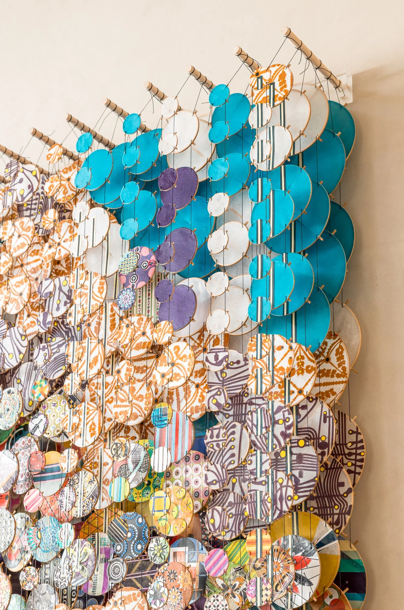 Colorful circular decorative art installation with patterned designs and a small orange '1' sign at the top right.