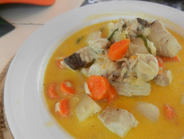 Fresh fish in a flavorful broth with carrots and veggies
