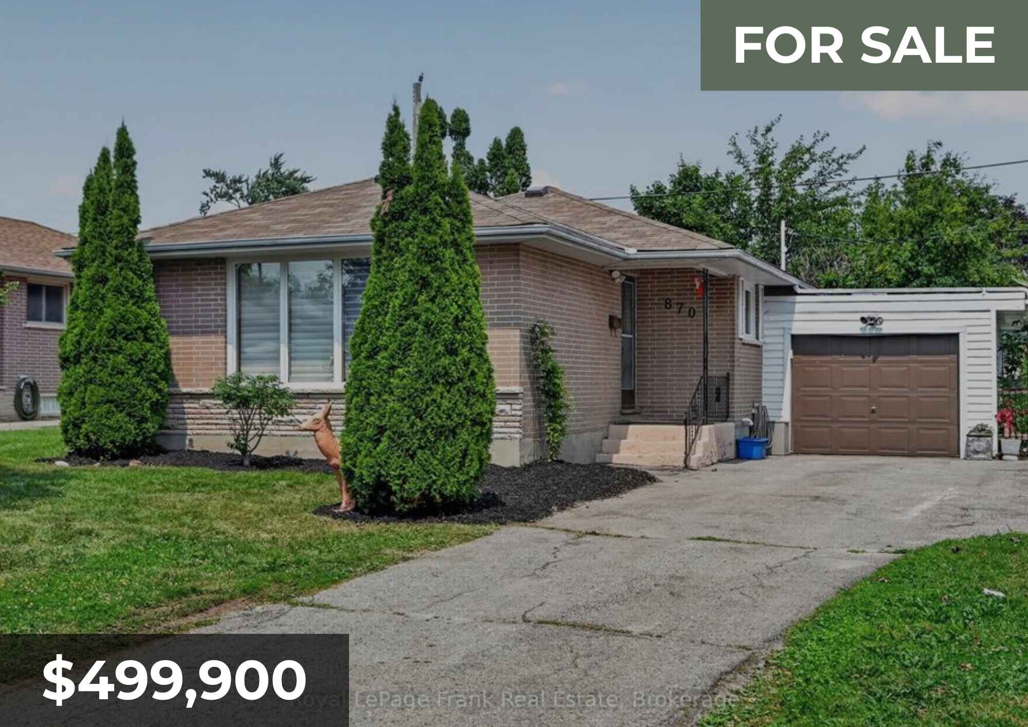 Front view of a brick house with a garage and a small front porch, two tall green shrubs, a small landscaped garden, and a dog standing near the shrubs, with a price tag of $499,900 and a 'For Sale' sign.
