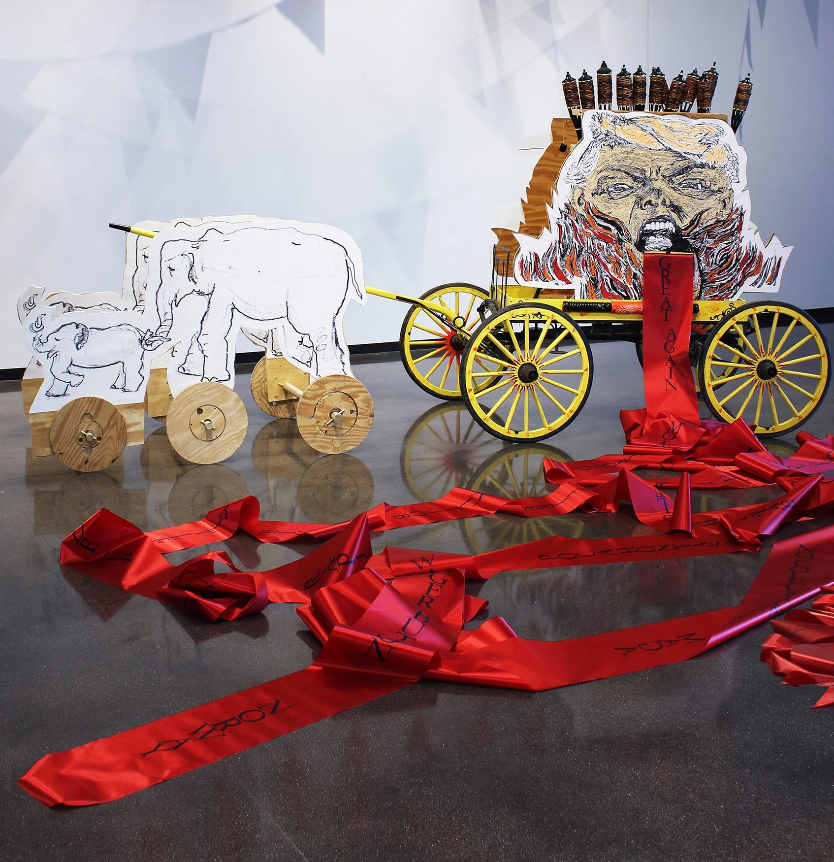  Hellmouth Circus Wagon. Inkjet print, jigsaw cut plywood, painted wagon, tiki torches, 100 yards of letterpress printed satin ribbon. Dimensions variable. 