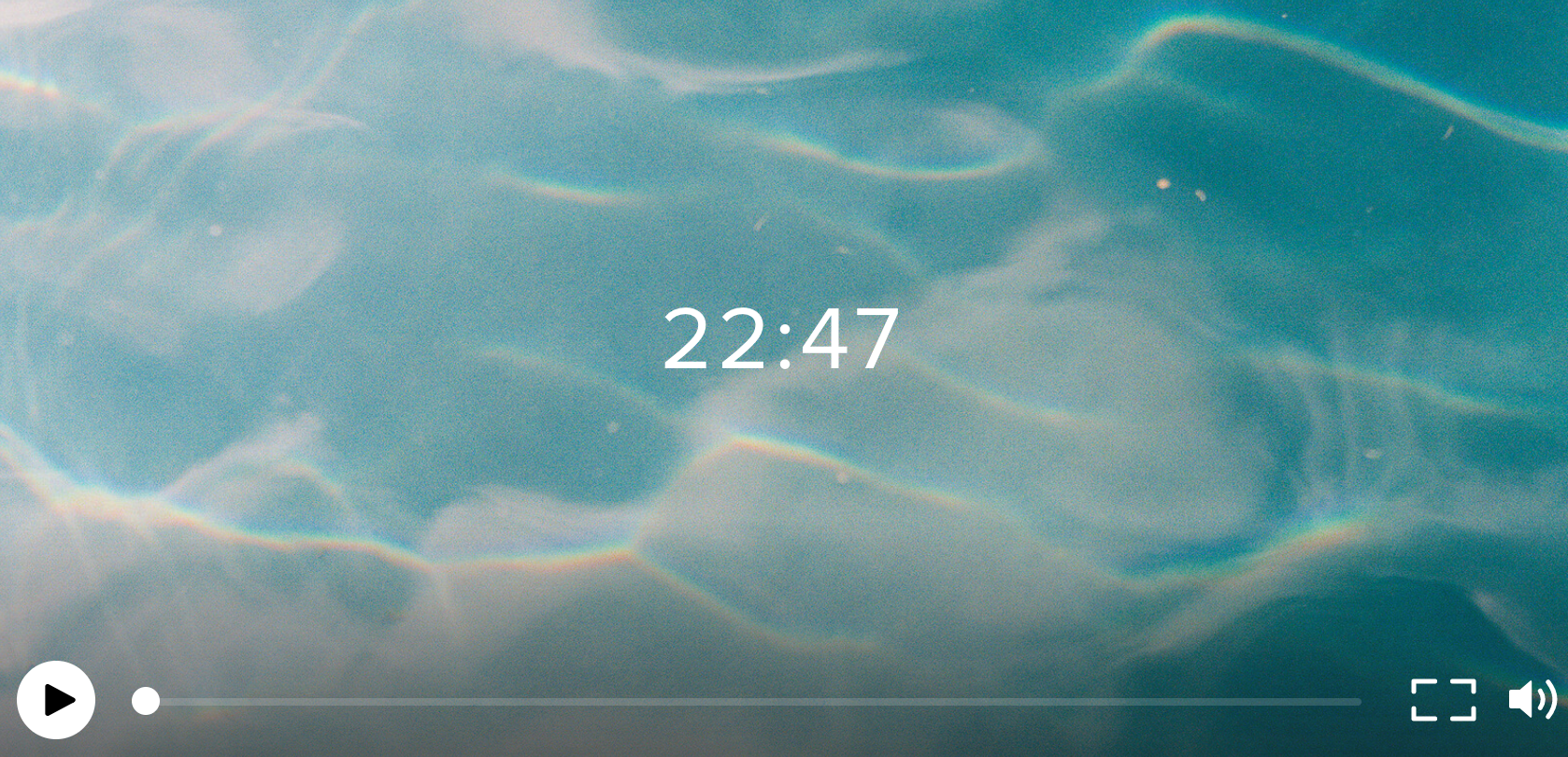 Screenshot of a video player with a background of light blue water with slight ripples, showing the time 22:47 in the center.
