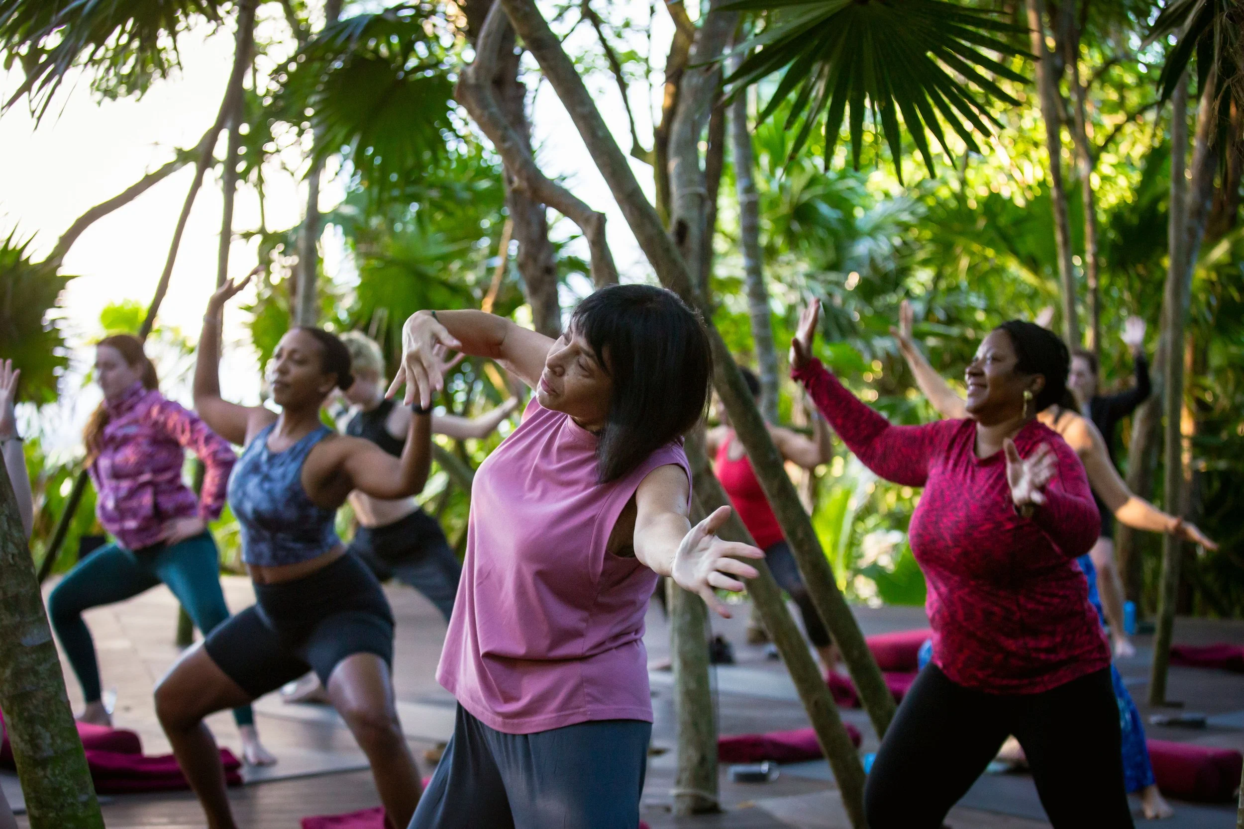 Photo of women dancing amongst trees