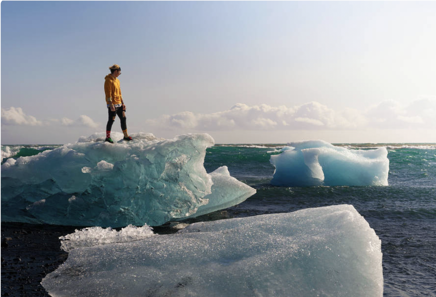 Man standing on glacier in ocean