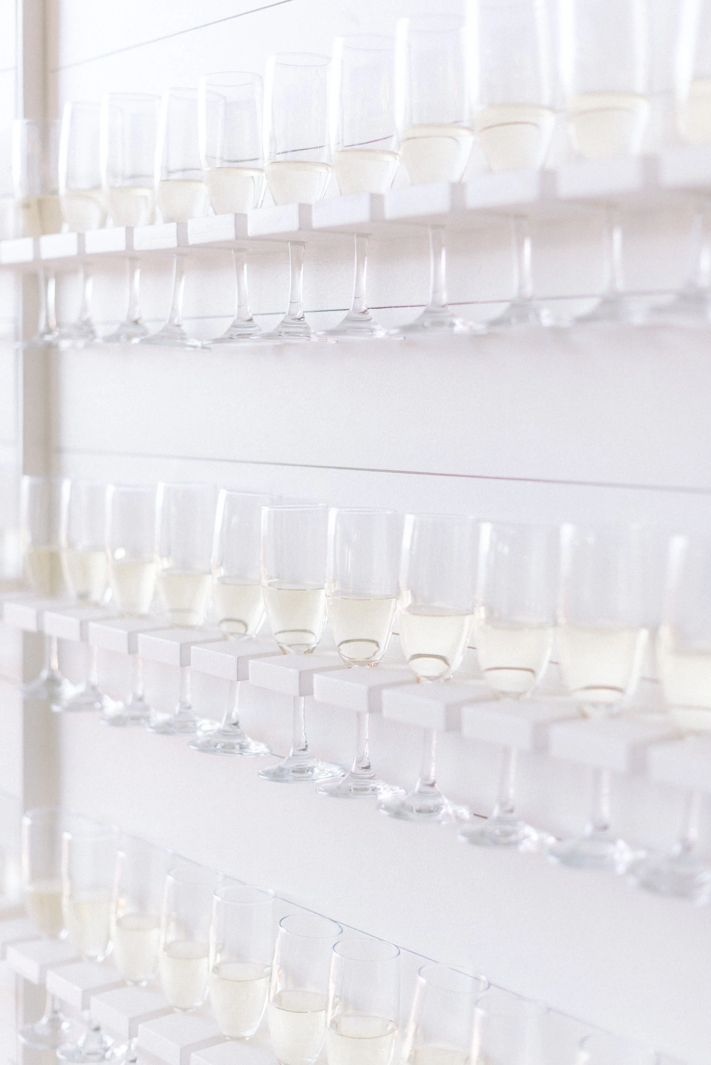 A welcome wall of champagne for guests to sip on a wedding day is a perfect way to start your ceremony.