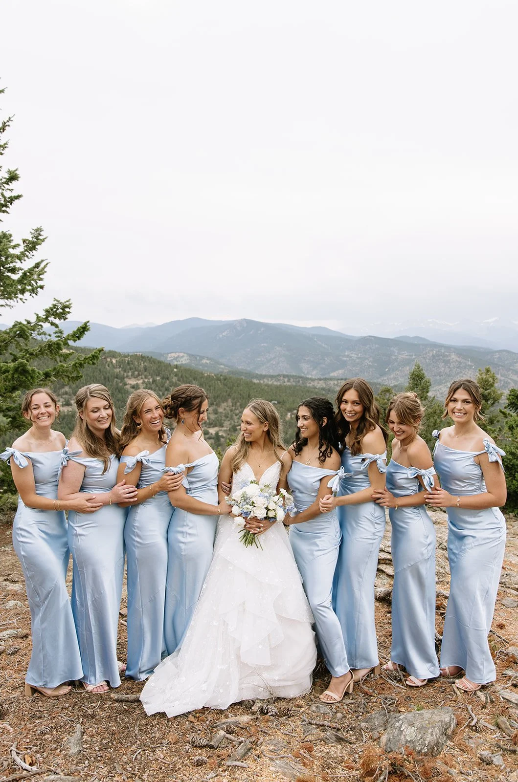bridesmaids in blue photographed on a mountaintop in Colorado