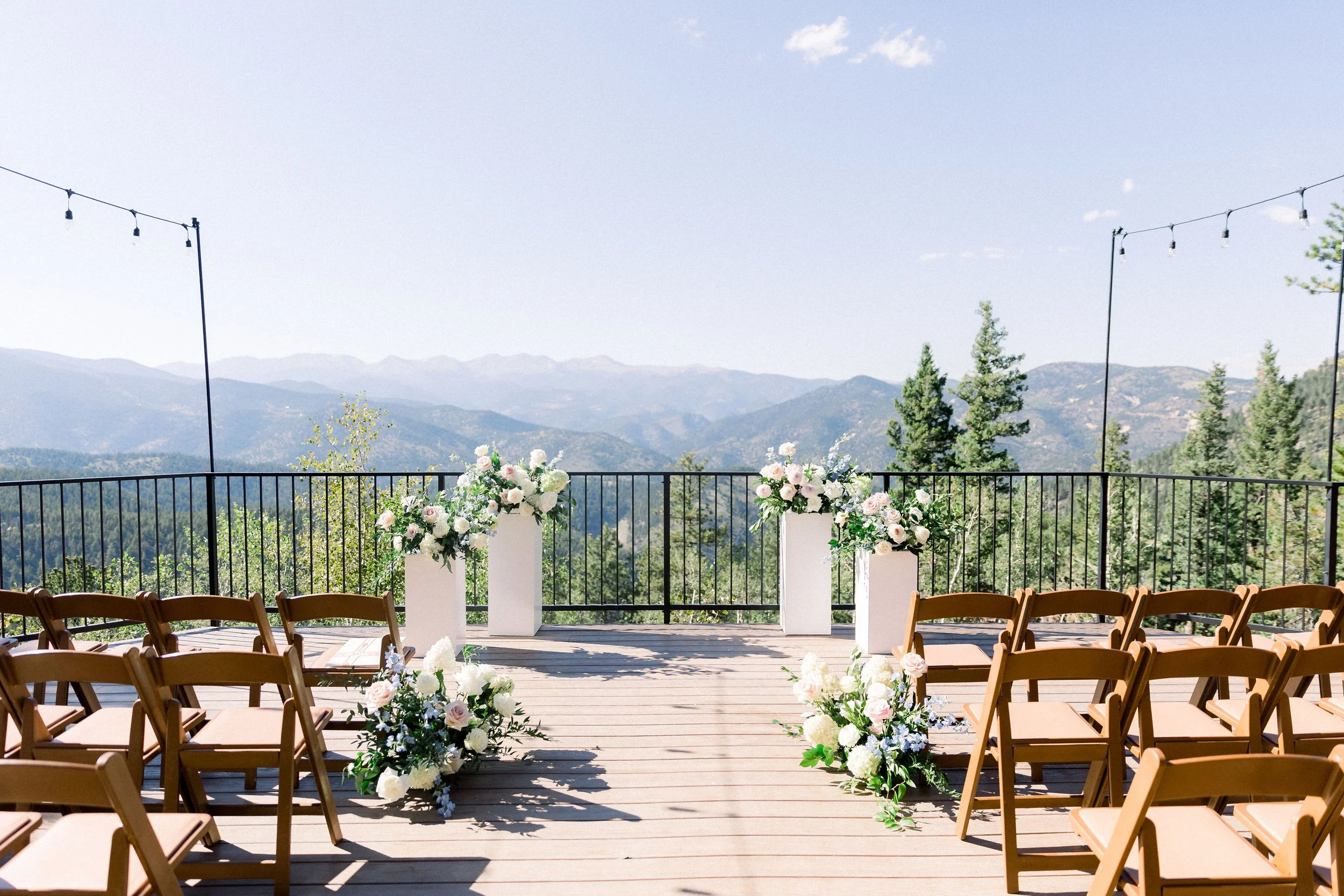 Mountain wedding view in Colorado framed by florals designed by Figment Floral for a ceremony.