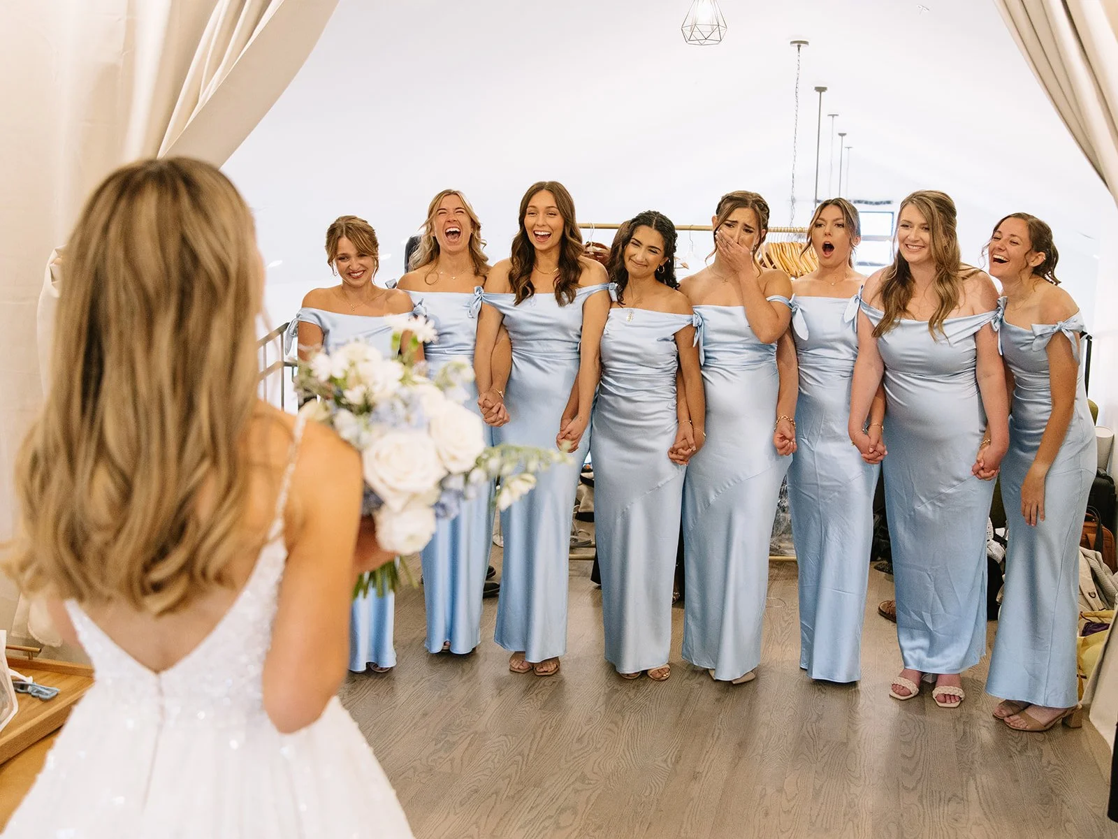 bridesmaid first look with the girls holding hands and crying with joy