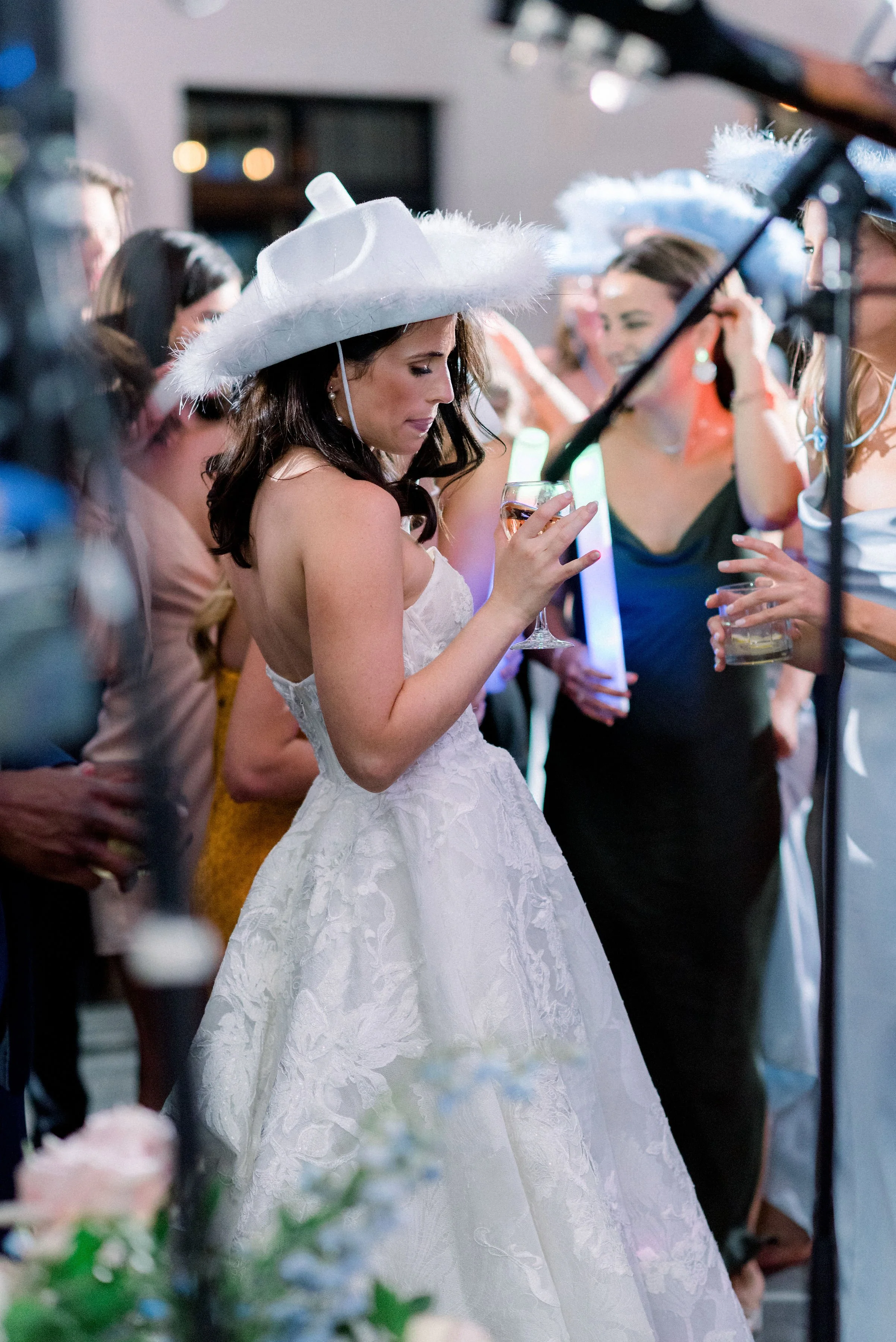 All night party on your wedding day at North Star Gatherings. The bride dances with a fluffy cowgirl hat and light up sticks.