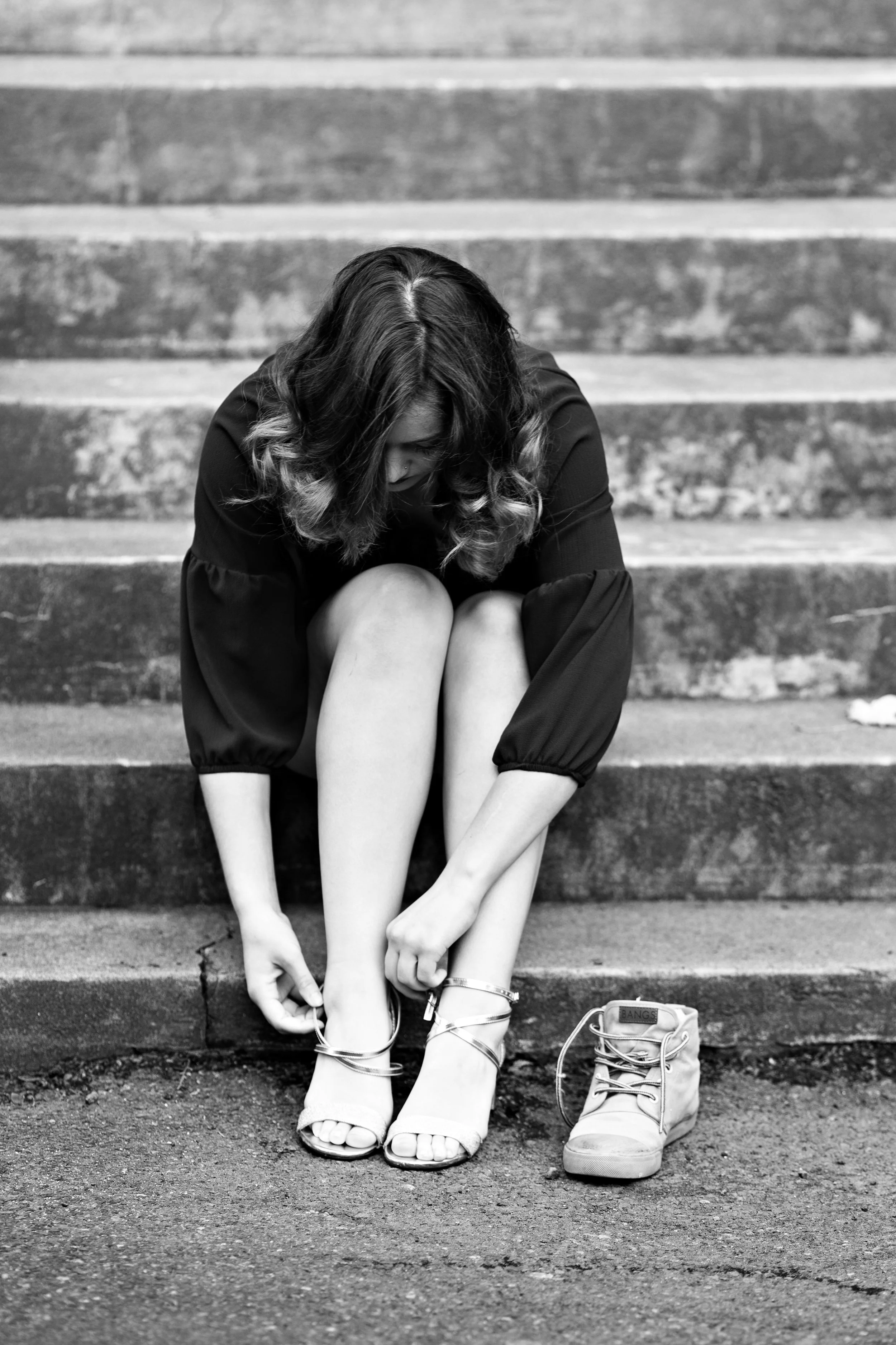 high school senior girl buckling her sandle