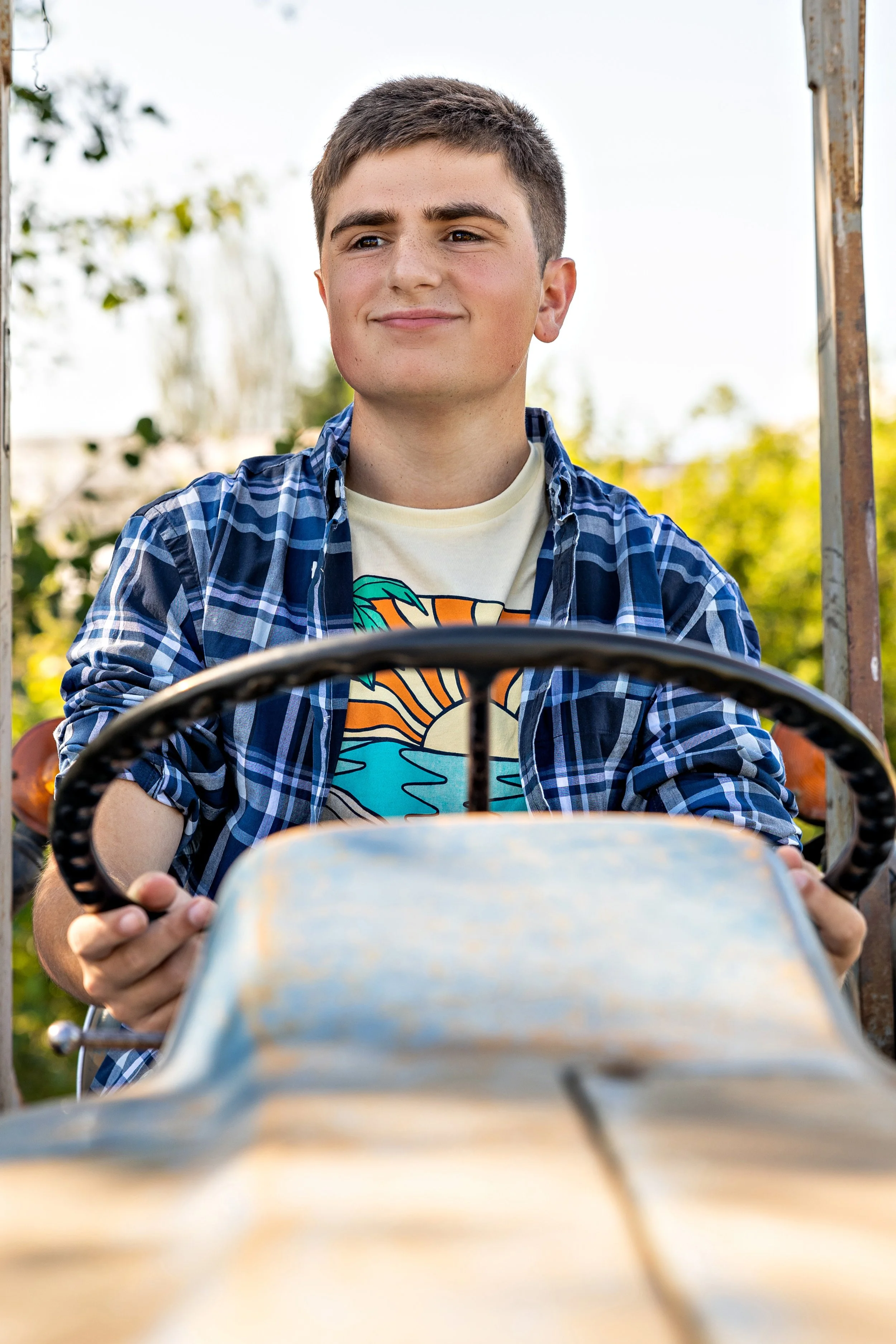 high school senior boy on a tractor
