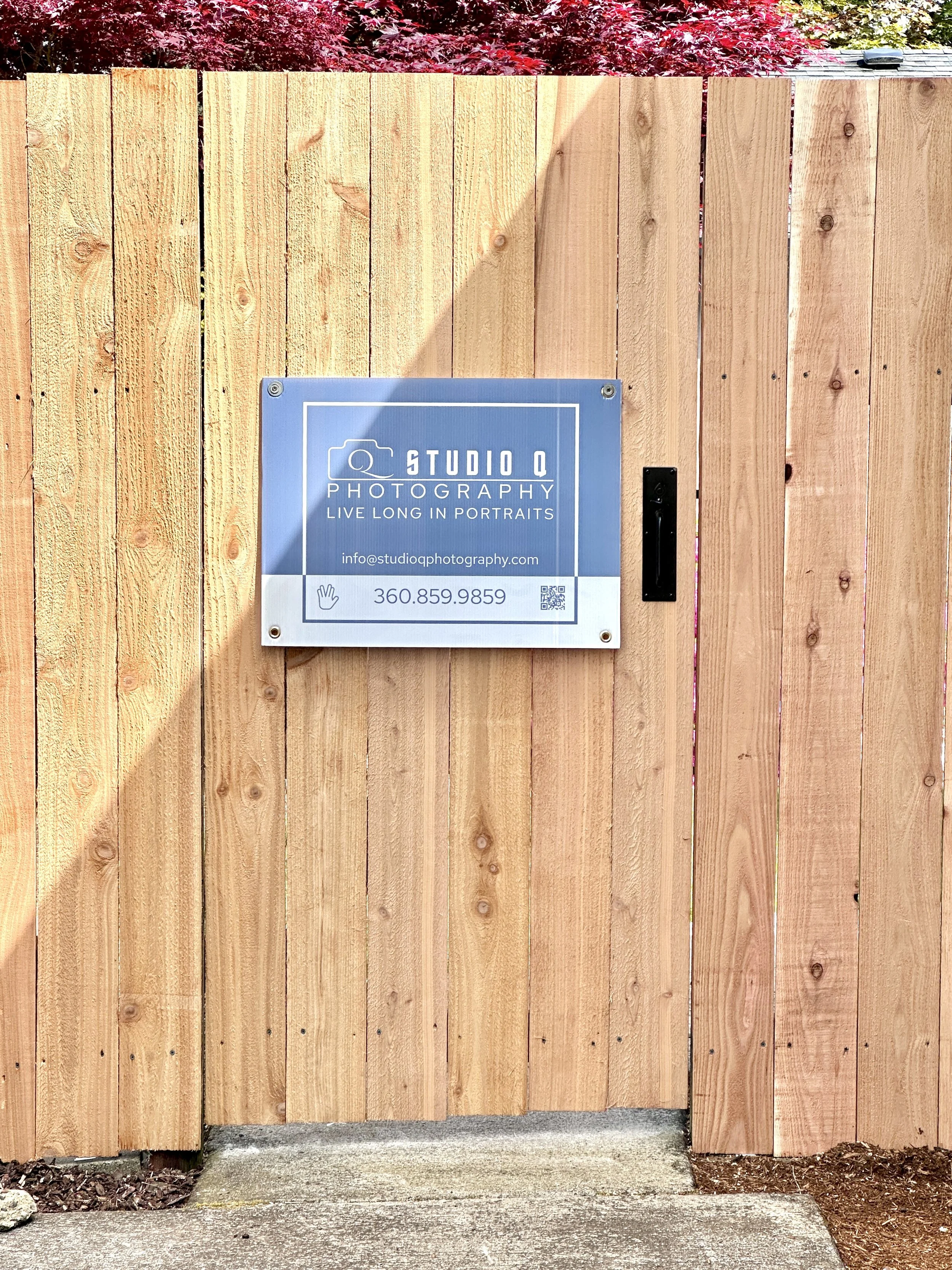 Gate with a Studio Q Photography sign on it