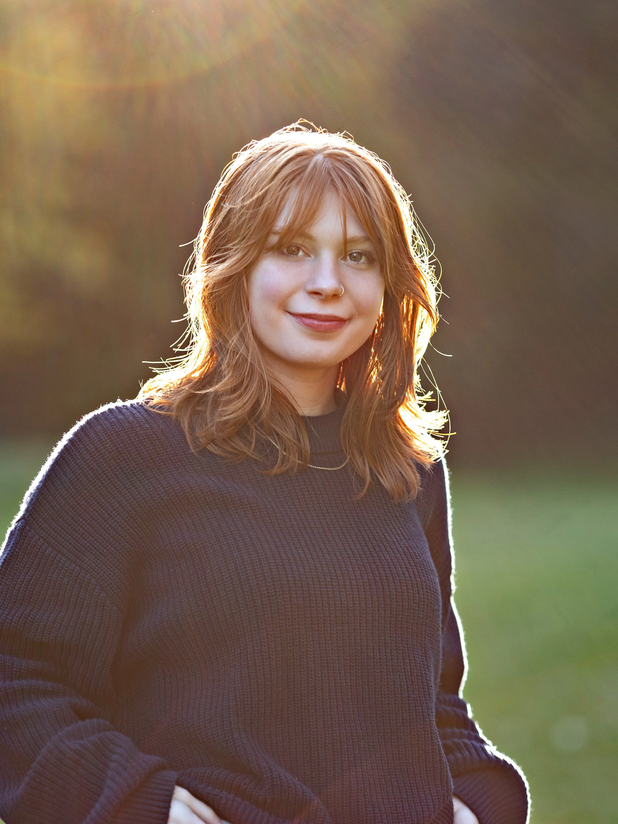 high school senior girl with sun lighting her hair