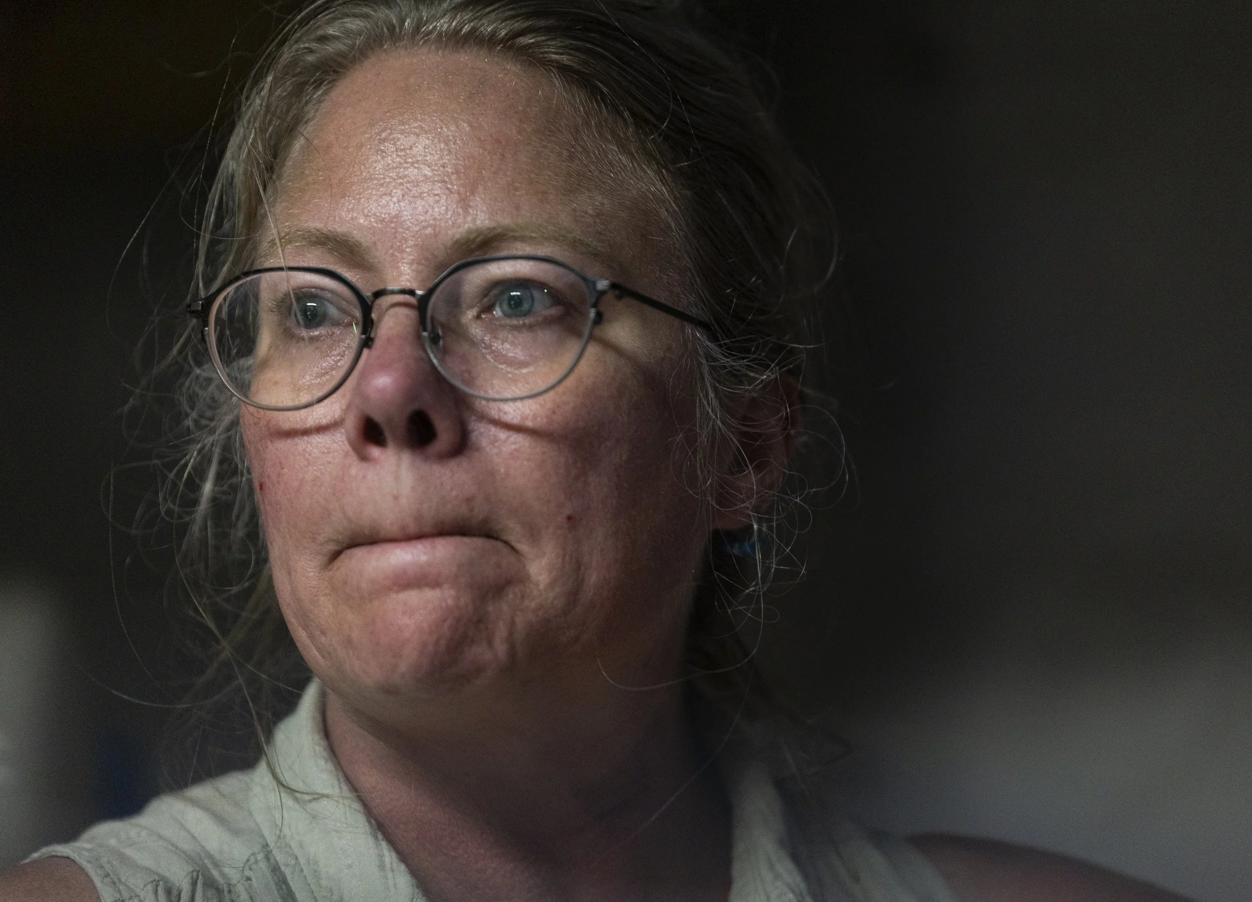 Lisa Heinz takes a break to rest from rinsing skeins of wool in the basement of her home in Athens, Ohio, September 4, 2025. She is recovering from a surgery earlier this year on her neck that left her unable to work for months. “I’ve only been back