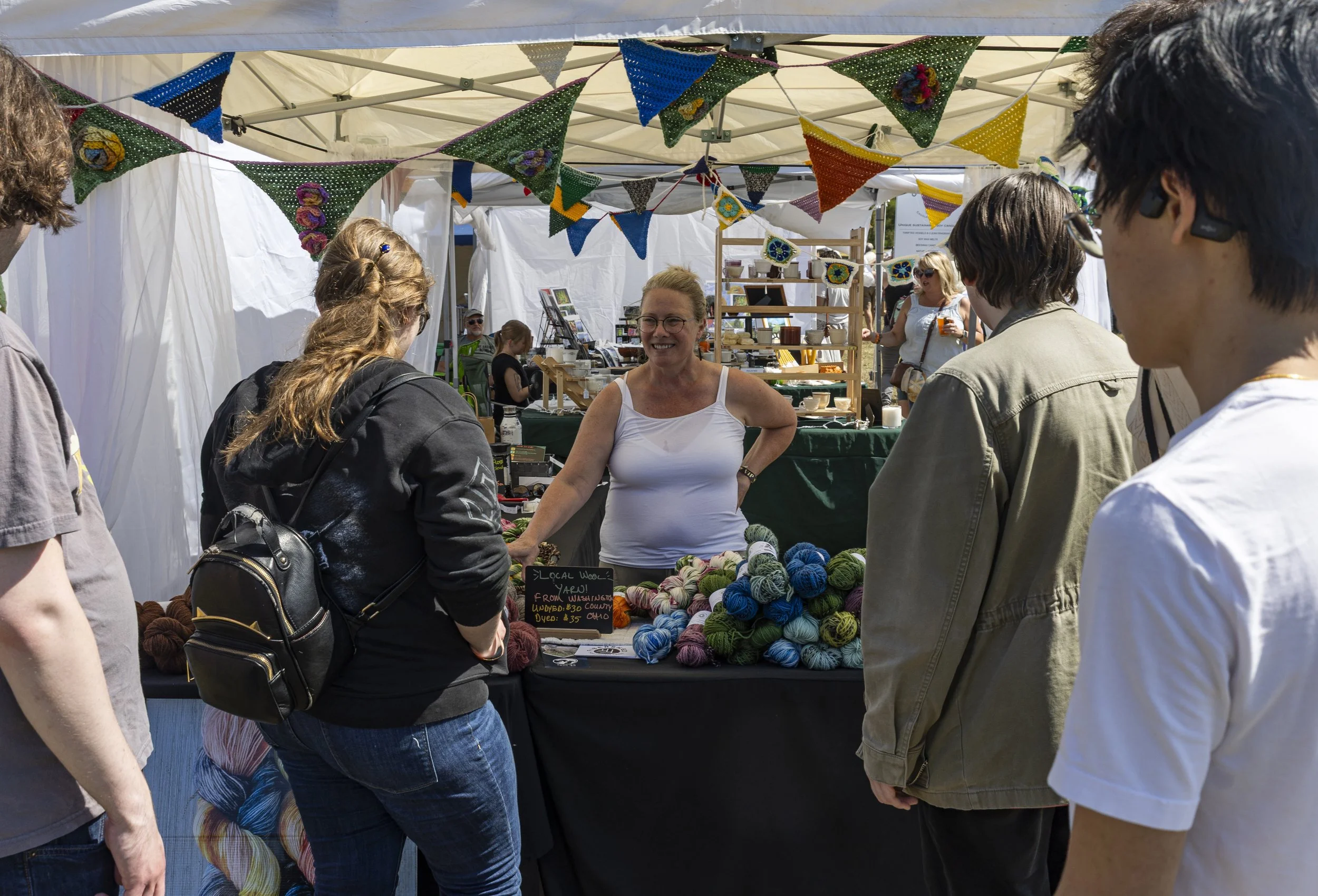 Lisa Heinz talks with customers in her tent at the Pawpaw Festival at Lake Snowden in Albany, Ohio, Sep. 13, 2025.