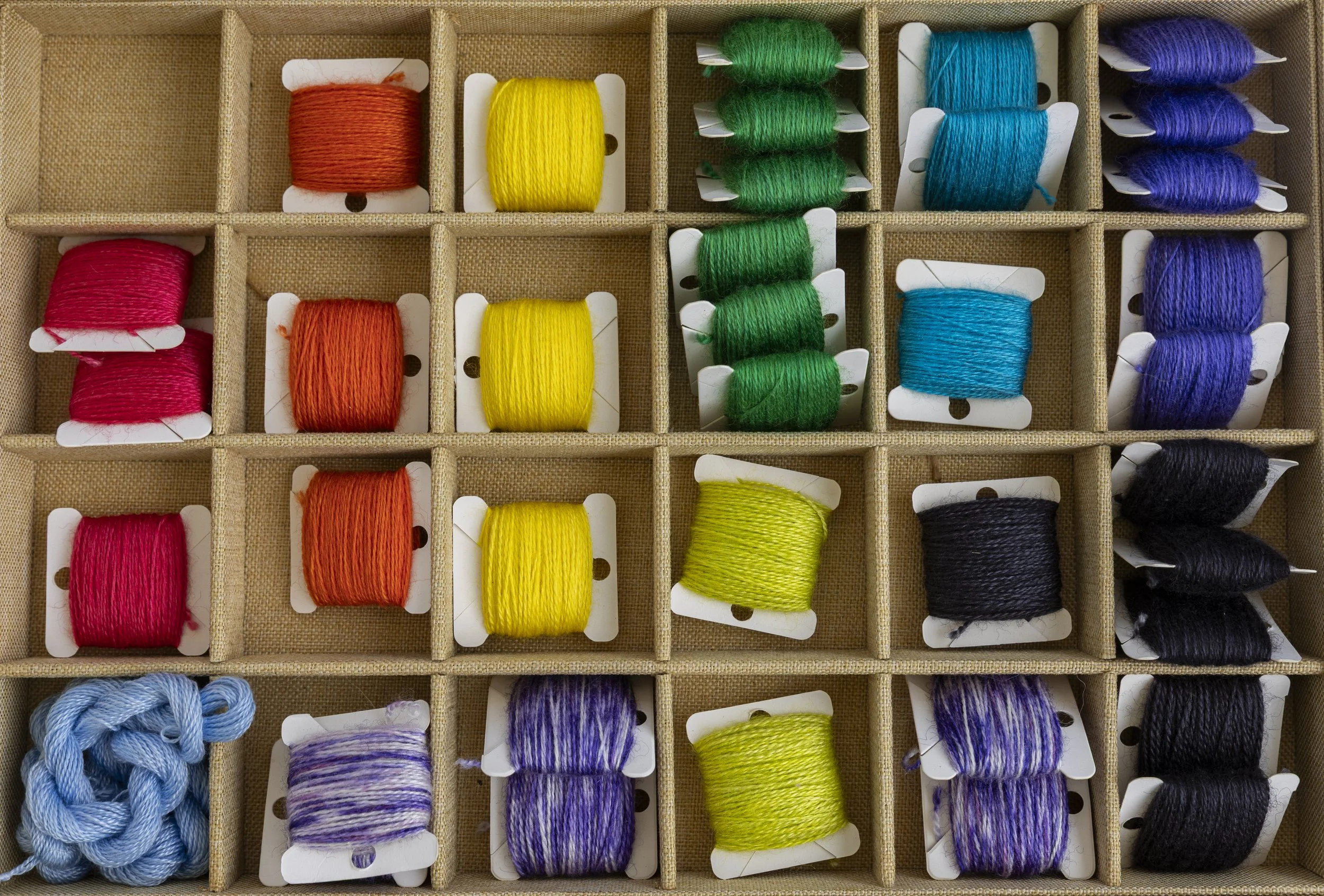 Packets of embroidery floss sit on a table at Lisa Heinz' booth at the Athens Art and Farmers Market at the Athens Community Center in Athens, Ohio, September 6, 2025.All the packs of floss are hand wound using the wool she sources. She said customer