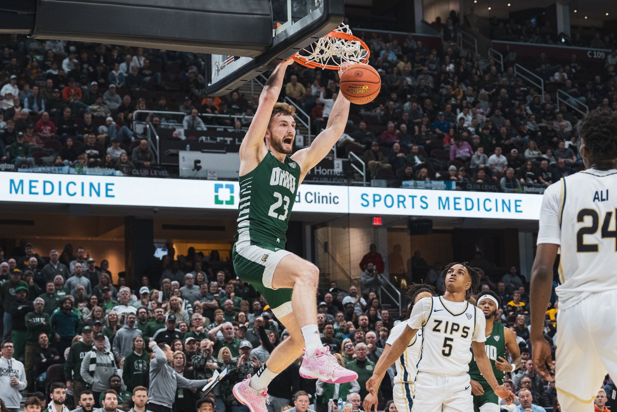 Ohio Bobcats forward AJ Clayton (23) slam dunks against Akron in the MAC Men's Basketball Semifinals at Rocket Mortgage Fieldhouse in Cleveland, Ohio, Mar. 15, 2024. Clayton scored seven points for Ohio. The Bobcats lost to the Zips 65-62. | Shot fo