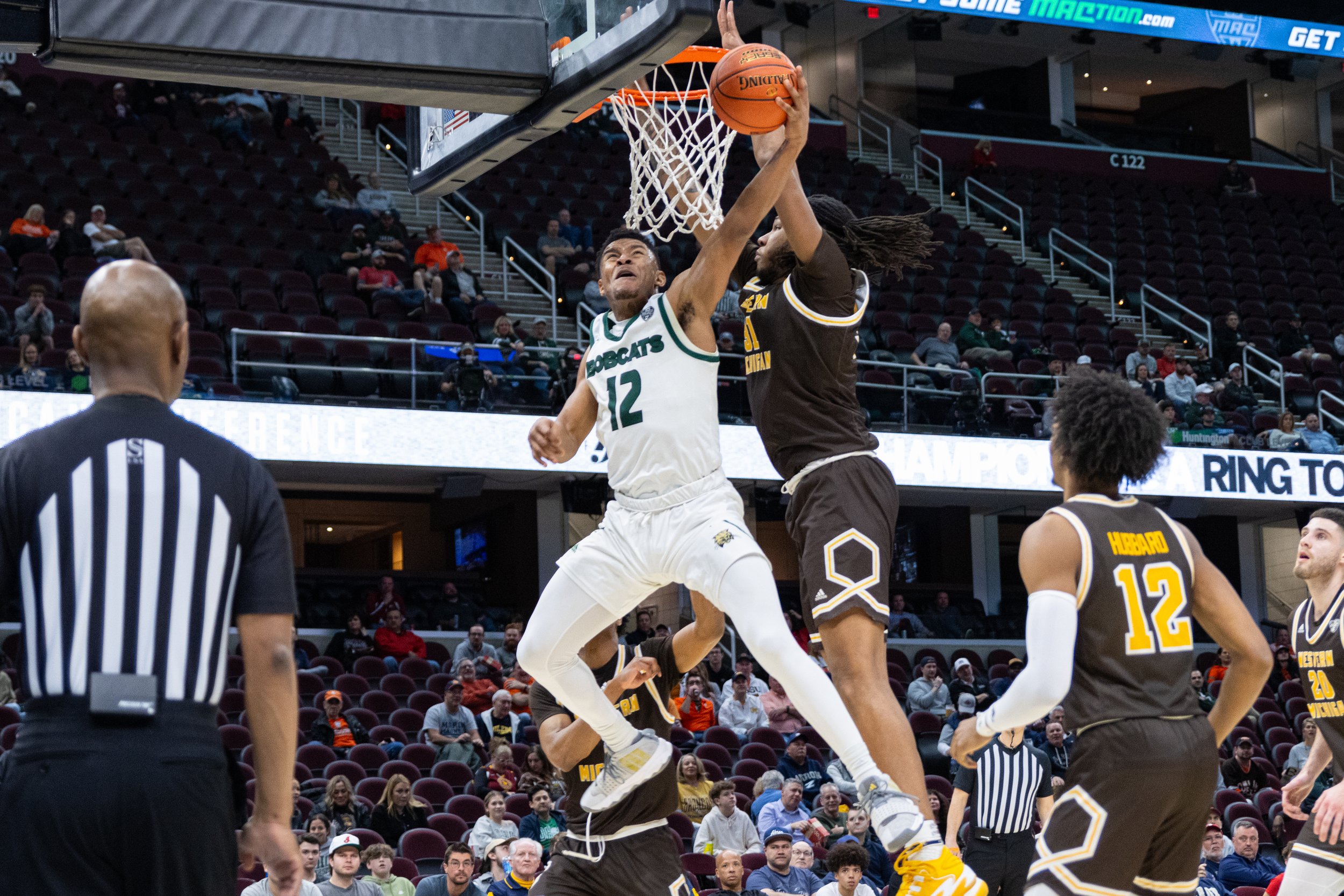 Ohio Bobcats guard Jaylin Hunter (12) goes for the net against Western Michigan in the MAC Men's Basketball Tournament at Rocket Mortgage Fieldhouse in Cleveland, Ohio, Mar. 14, 2024. Mitchell scored 13 points, helping the Bobcats beat the Broncos 82