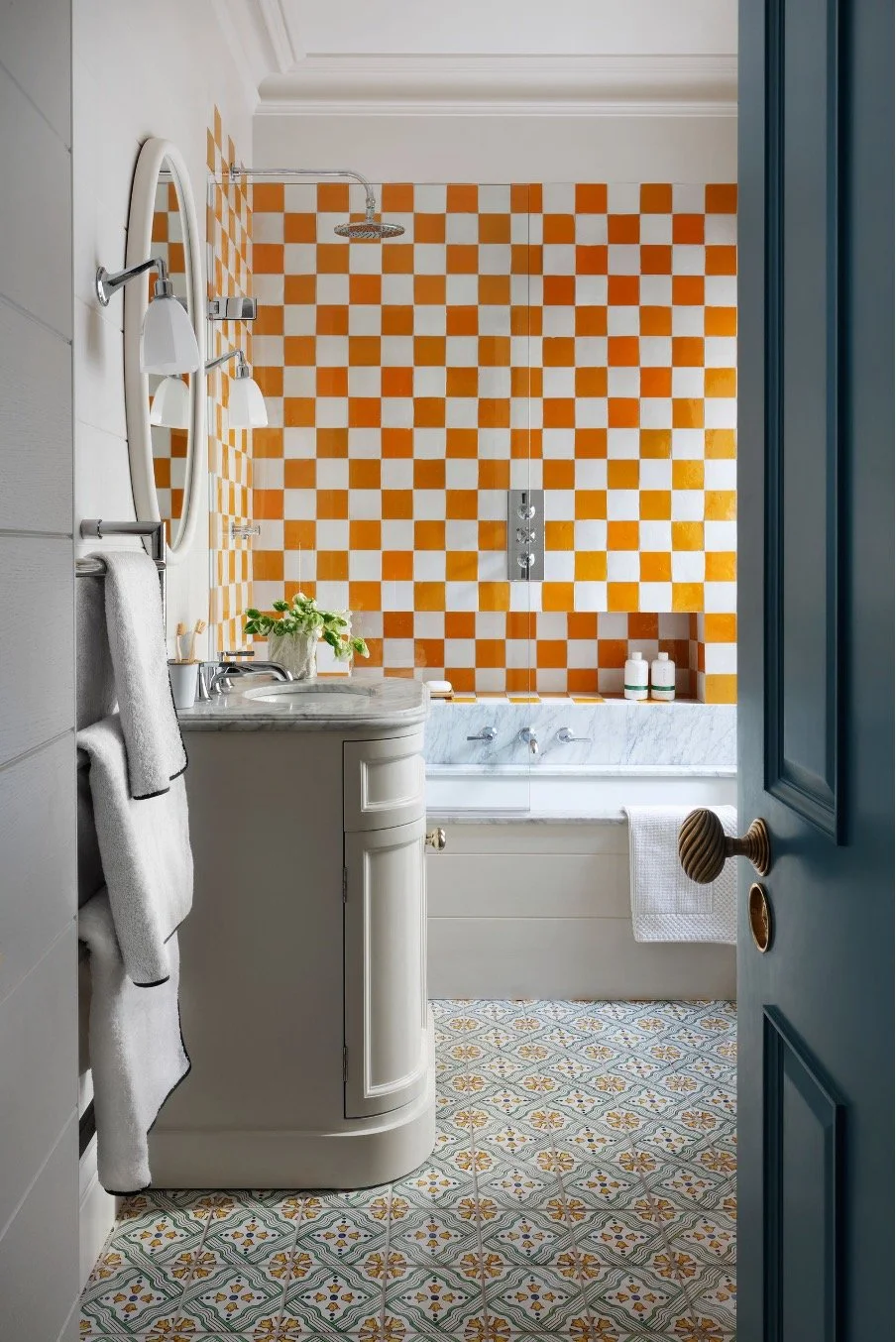 Bathroom in a period house curved vanity unit heated towel rail patterned floor and wall tiles