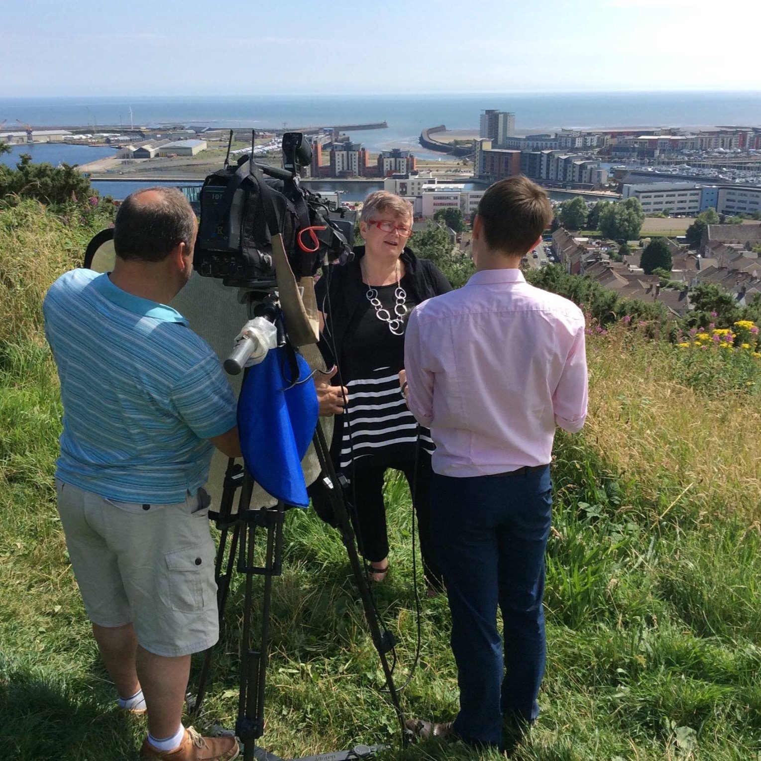 Carolyn interviewed by news crew overlooking Swansea