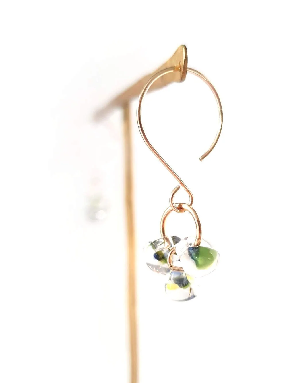 close up image on stand of the seasonal earrings grass sterling