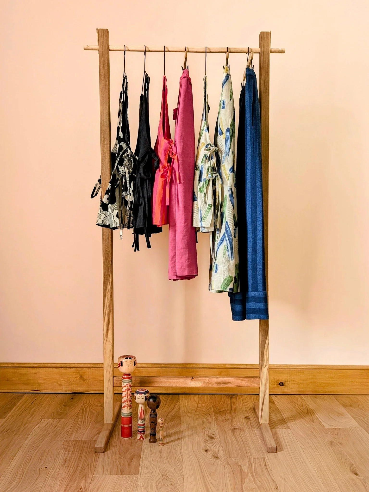 a wooden rack with handmade clothing