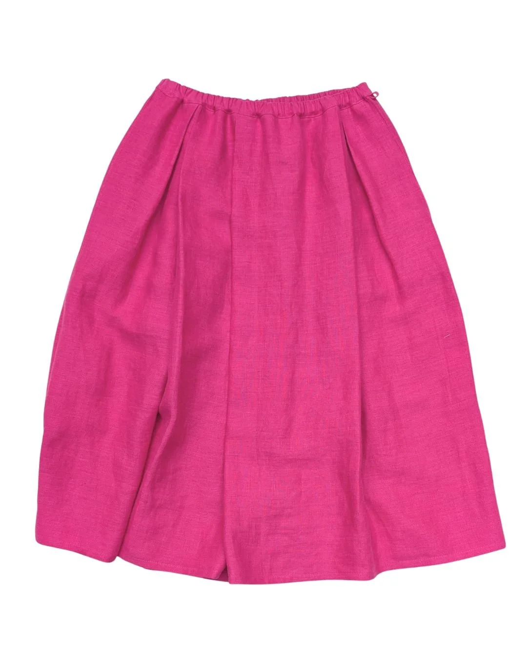 a flat lay of a bright candy pink linen skirt