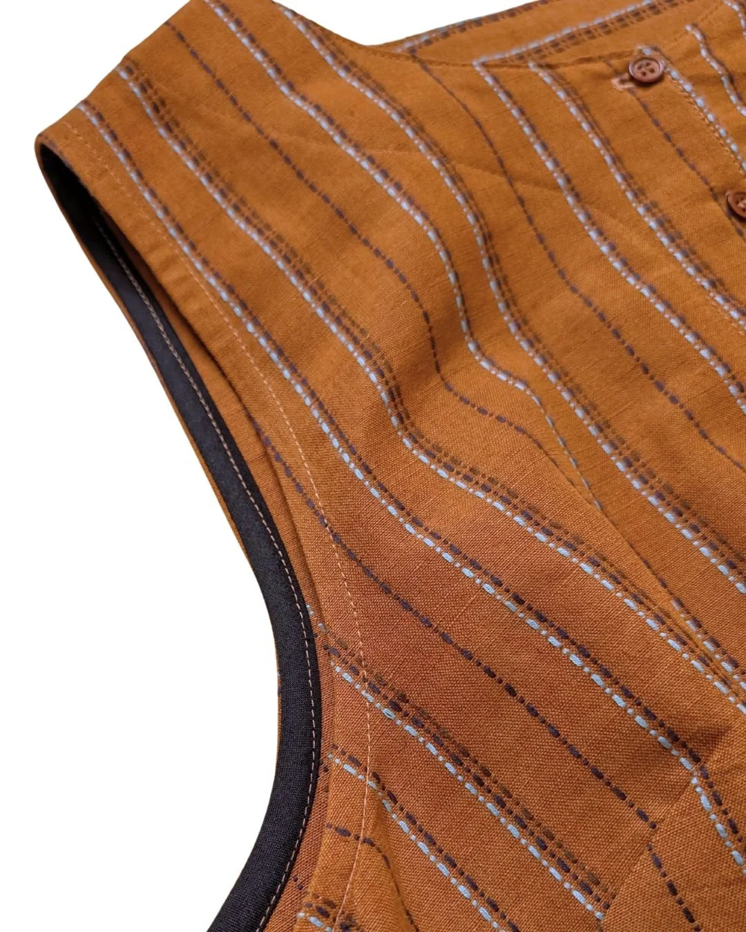 close up of the armhole of brown nara pinafore