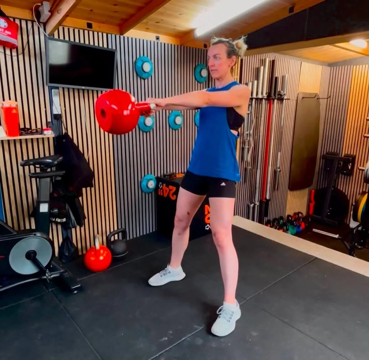 Personal training client Annabelle in the gym using a kettlebell