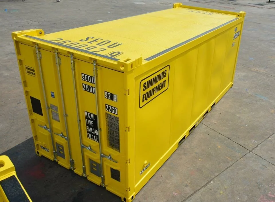 Yellow shipping container with 'Simmons Equipment' branding, placed on a concrete surface. Offshore container Simmonds Equipment dnv2.7-1 