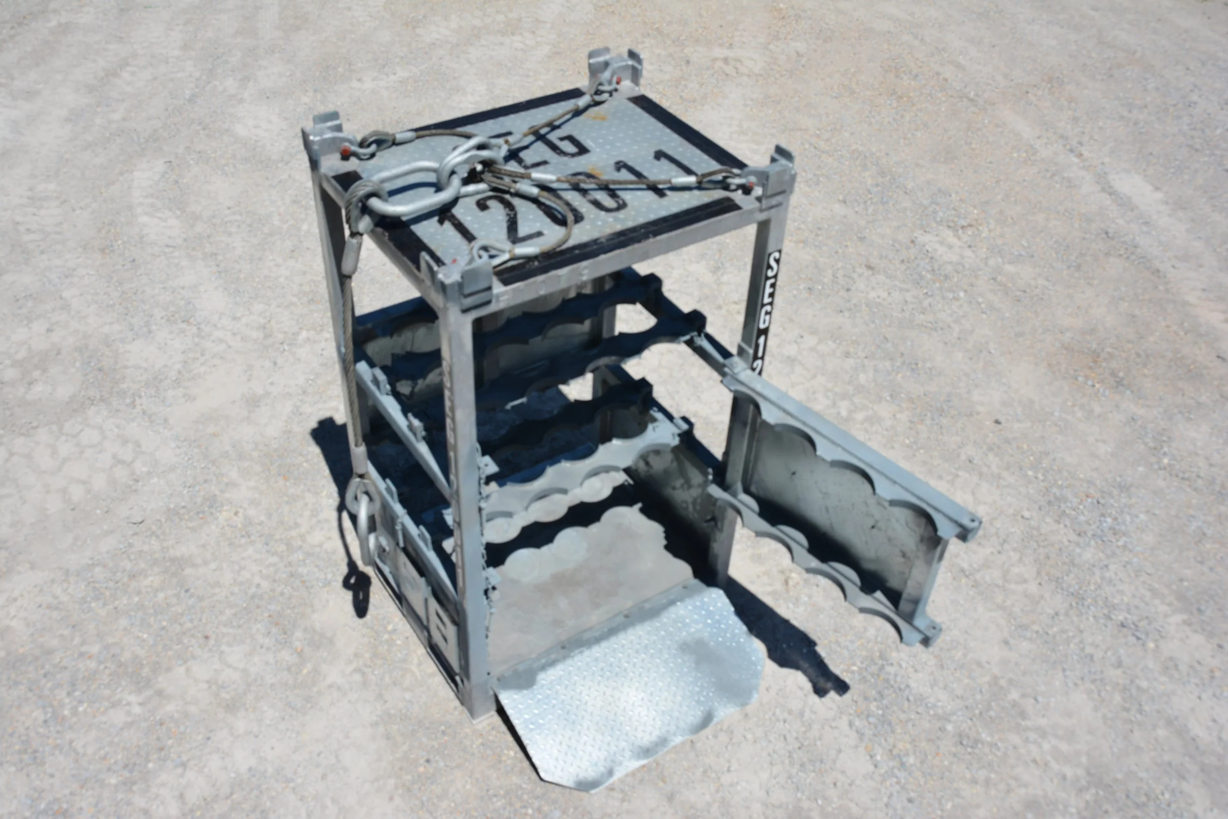 A metal robot or machine with a modular frame, attached wires, and compartments, placed on a sandy outdoor surface. yellow gas rack Offshore container Simmonds Equipment dnv2.7-1 Galvanised galvanized 
