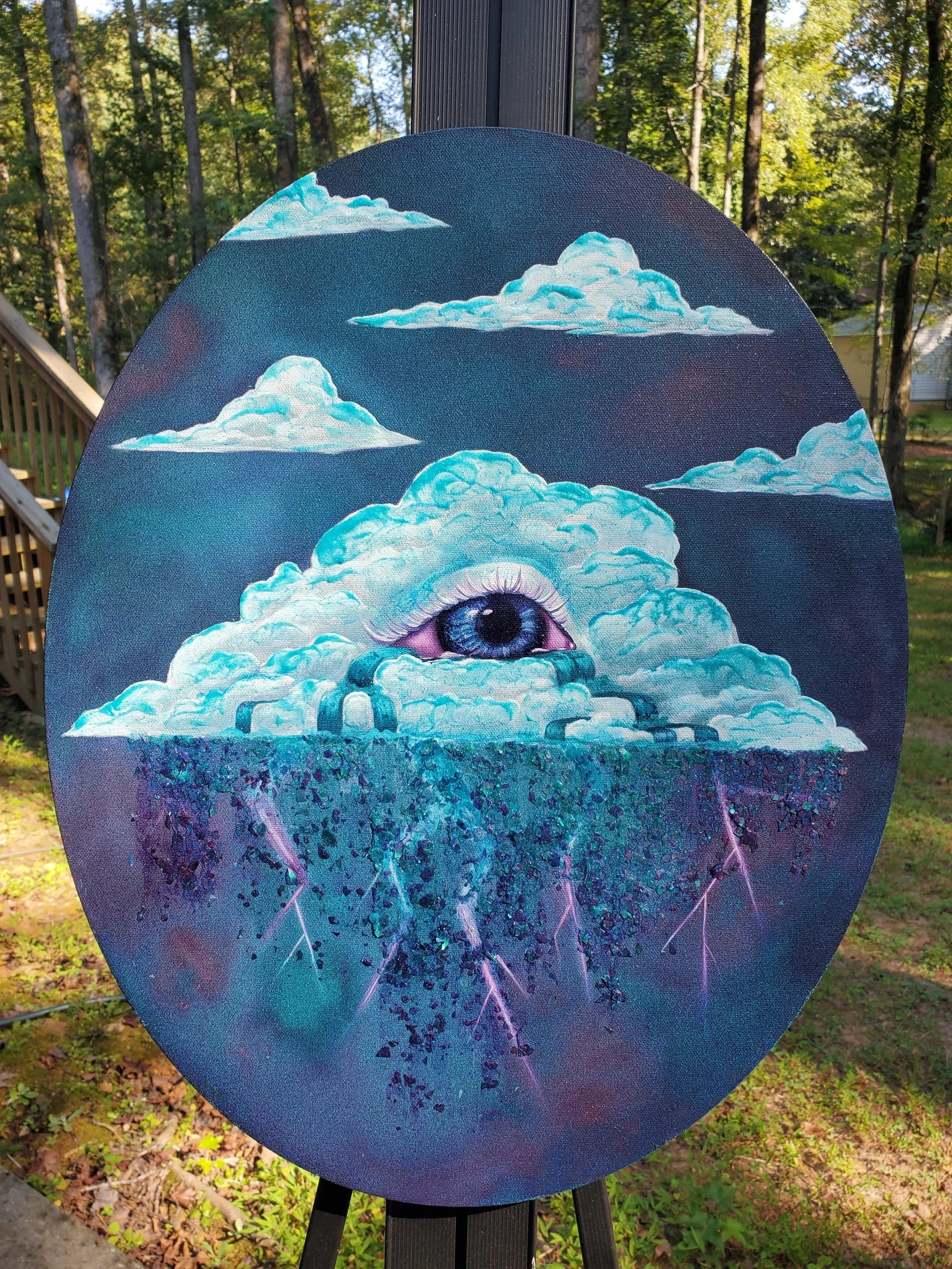 Painting on a circular canvas featuring a surreal eye within clouds, surrounded by lightning, against a starry night sky background.