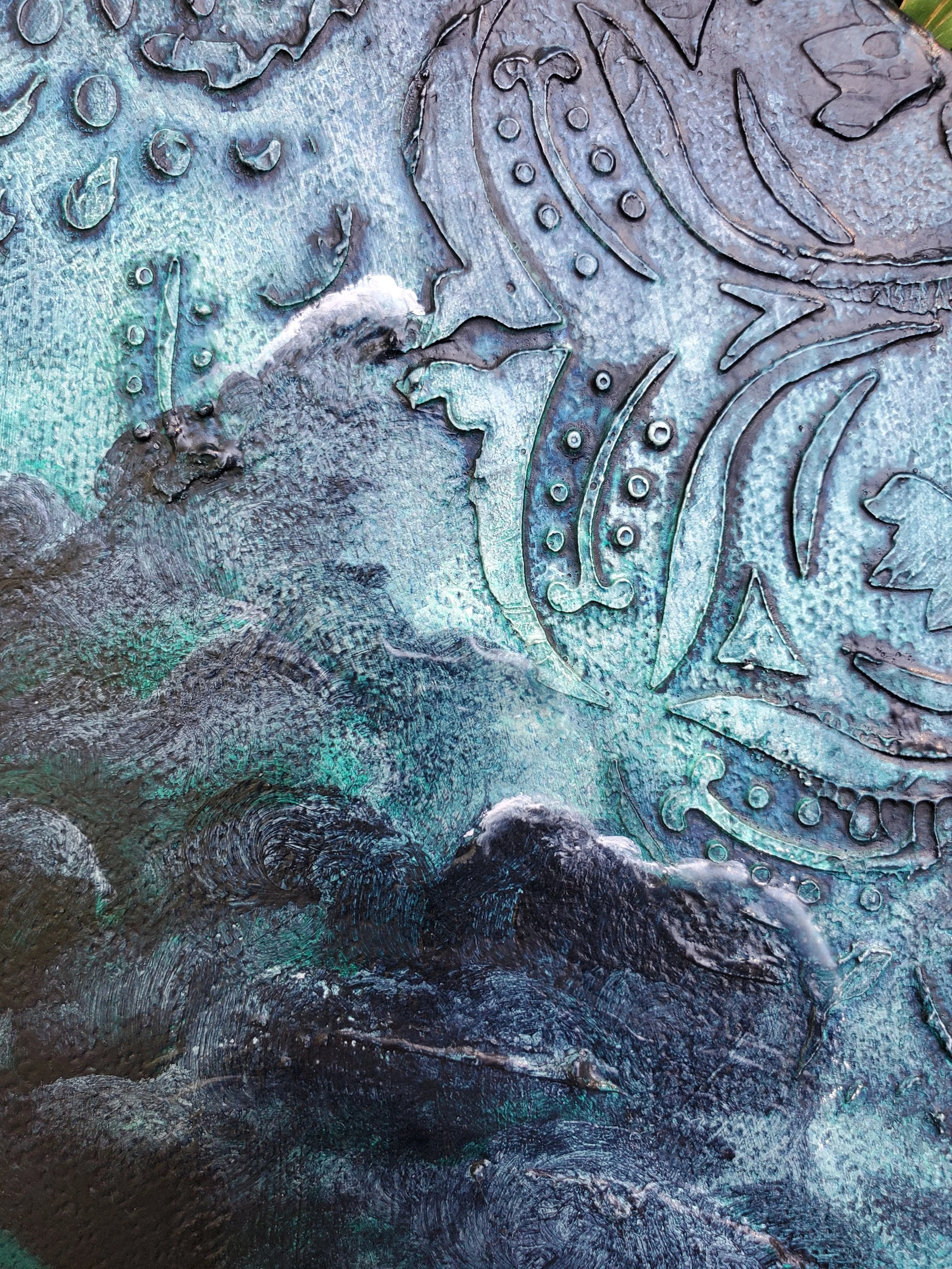 Close-up surface with engraved and embossed patterns, including abstract designs, with a textured, weathered appearance and hints of iridescent coloring.