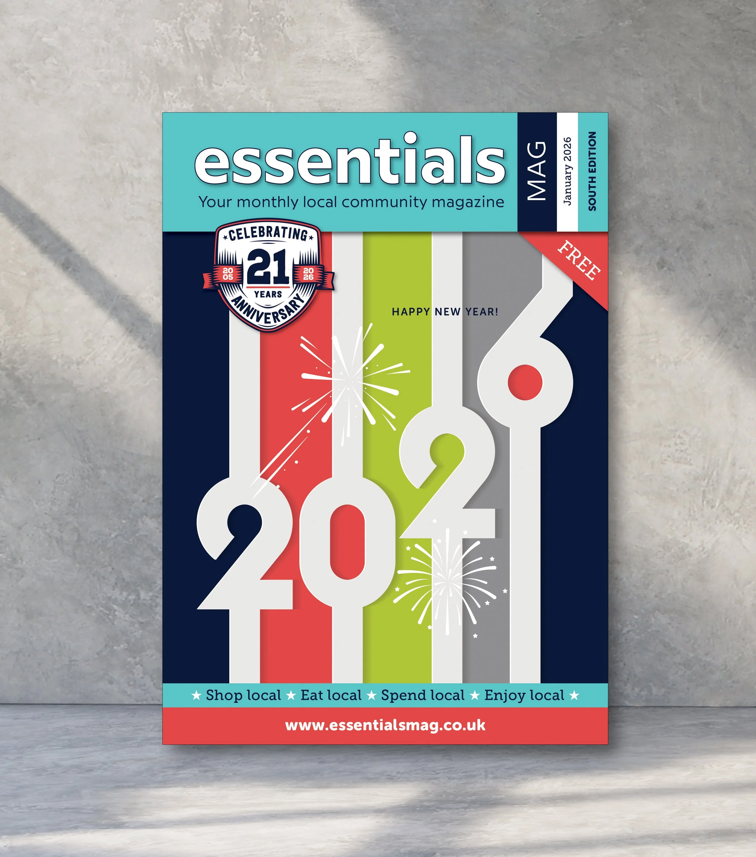 A magazine cover celebrating the New Year 2021 with colorful fireworks. The cover features the numbers '202' with each digit in a different color, and the phrase 'Happy New Year!' with additional text promoting local shopping, dining, spending, and enjoying the community. The magazine is titled 'Essentials' and indicates it is the January 202 edition for the South region, marking its 21st anniversary, and is free.