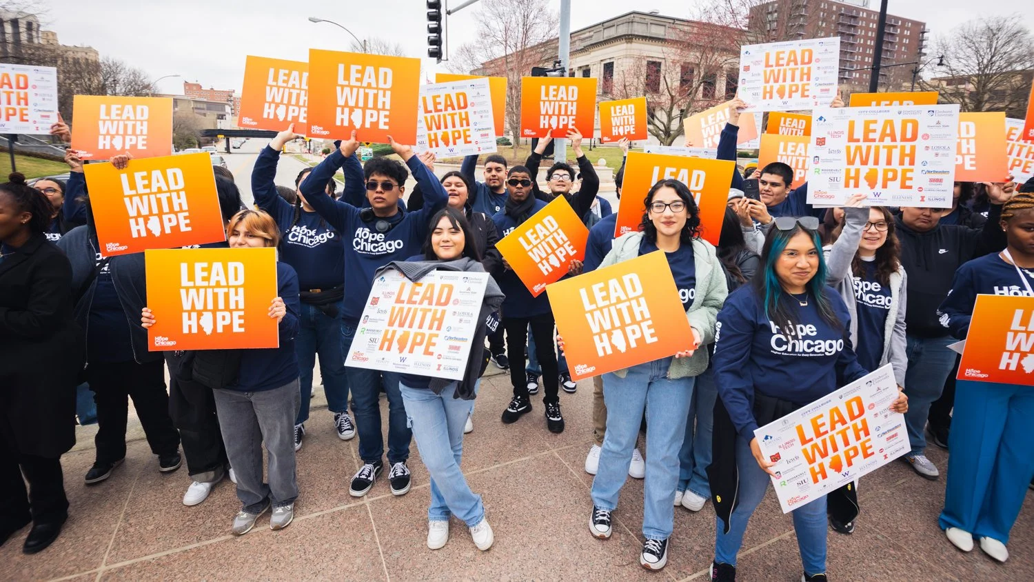 Photo of many Hope Scholars holding "Lead with Hope" signs down in Springfield, Illinois.