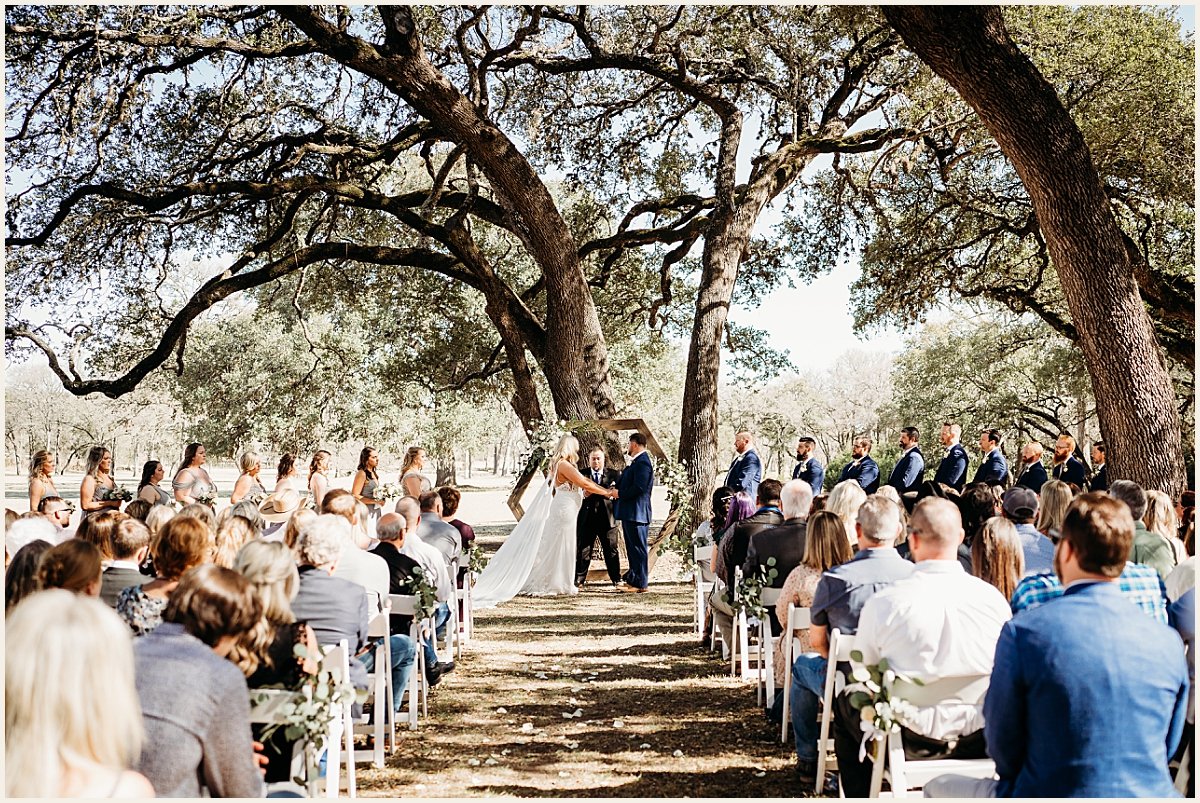 Bride and groom standing at the alter exchanging vows | Lauren Crumpler Photography | Texas Wedding Photographer