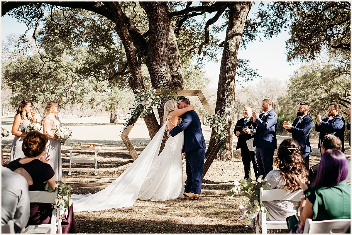 Bride and groom sharing their first kiss as husband and wife | Lauren Crumpler Photography | Texas Wedding Photographer