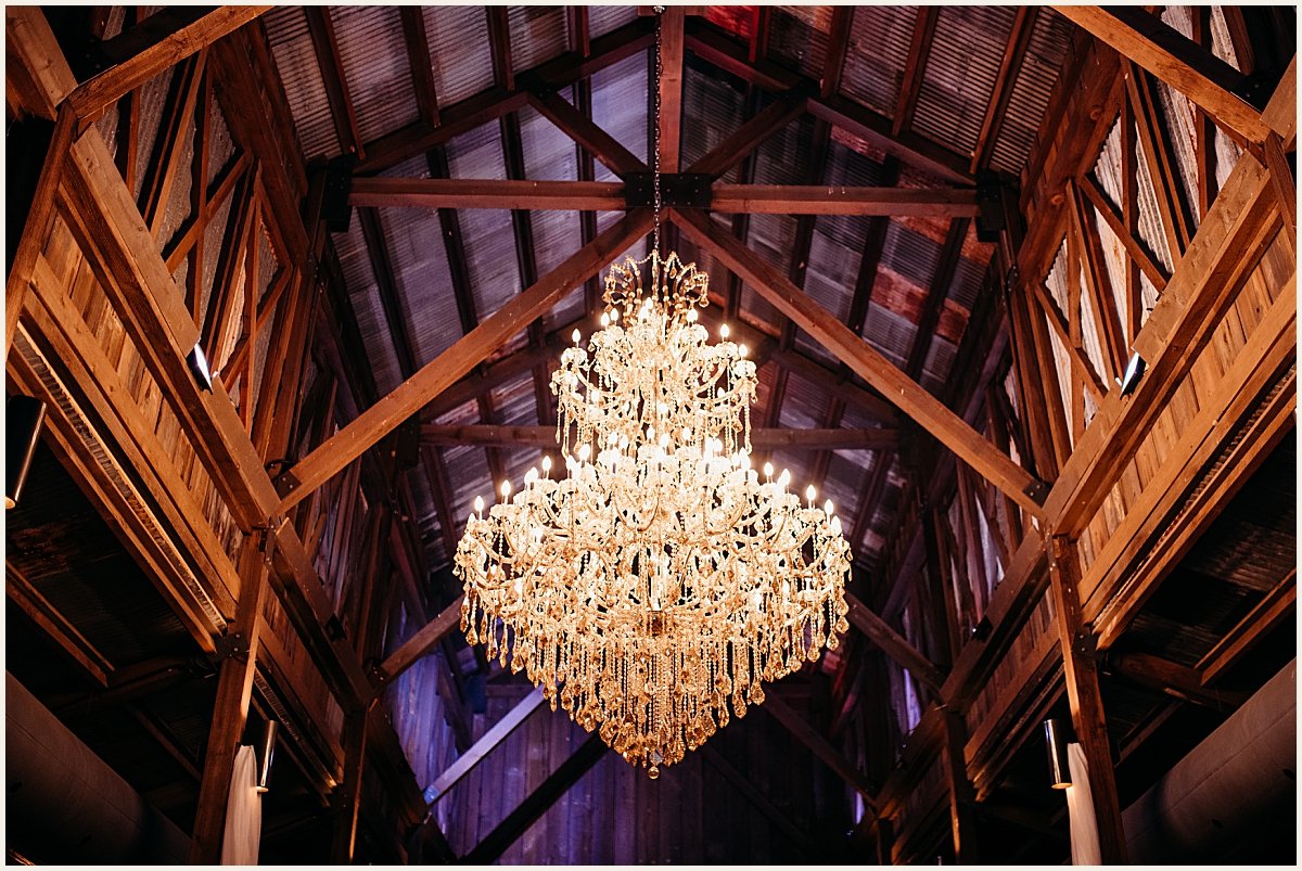 Rustic elegance shines through the barn chandeliers | Lauren Crumpler Photography | Texas Wedding Photographer