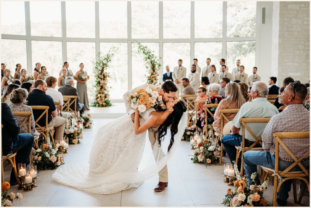 Bride and groom first kiss down the aisle | Lauren Crumpler Photography | Texas Wedding Photographer