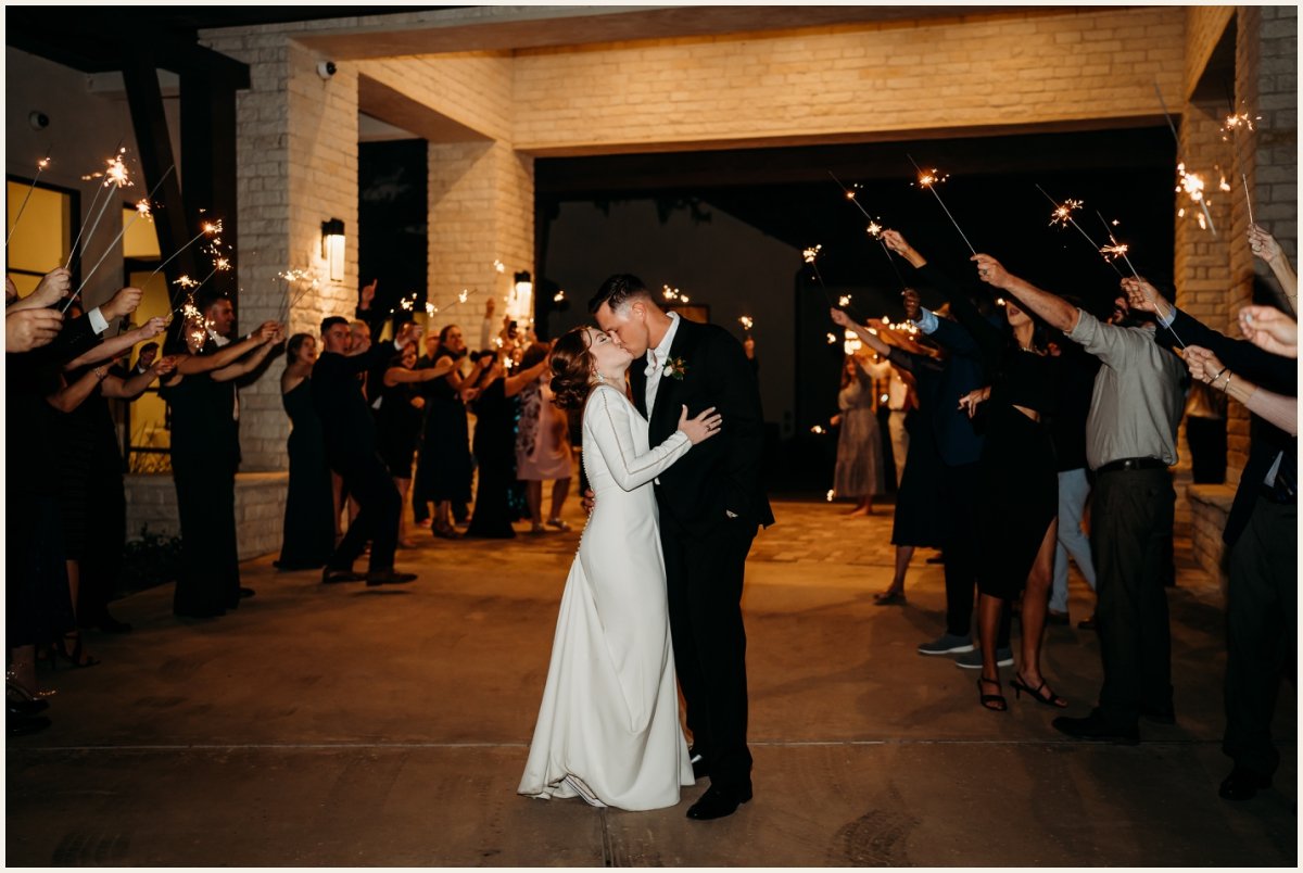 Kissing after the sparkler exit after the reception | Lauren Crumpler Photography | Texas Wedding Photographer
