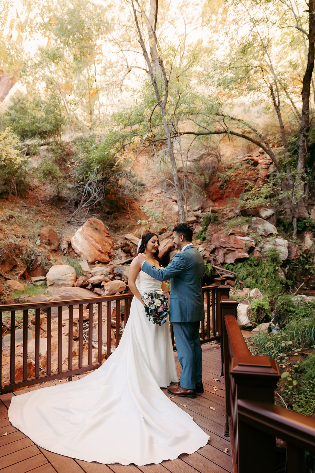  groom fixing the bride’s dress 