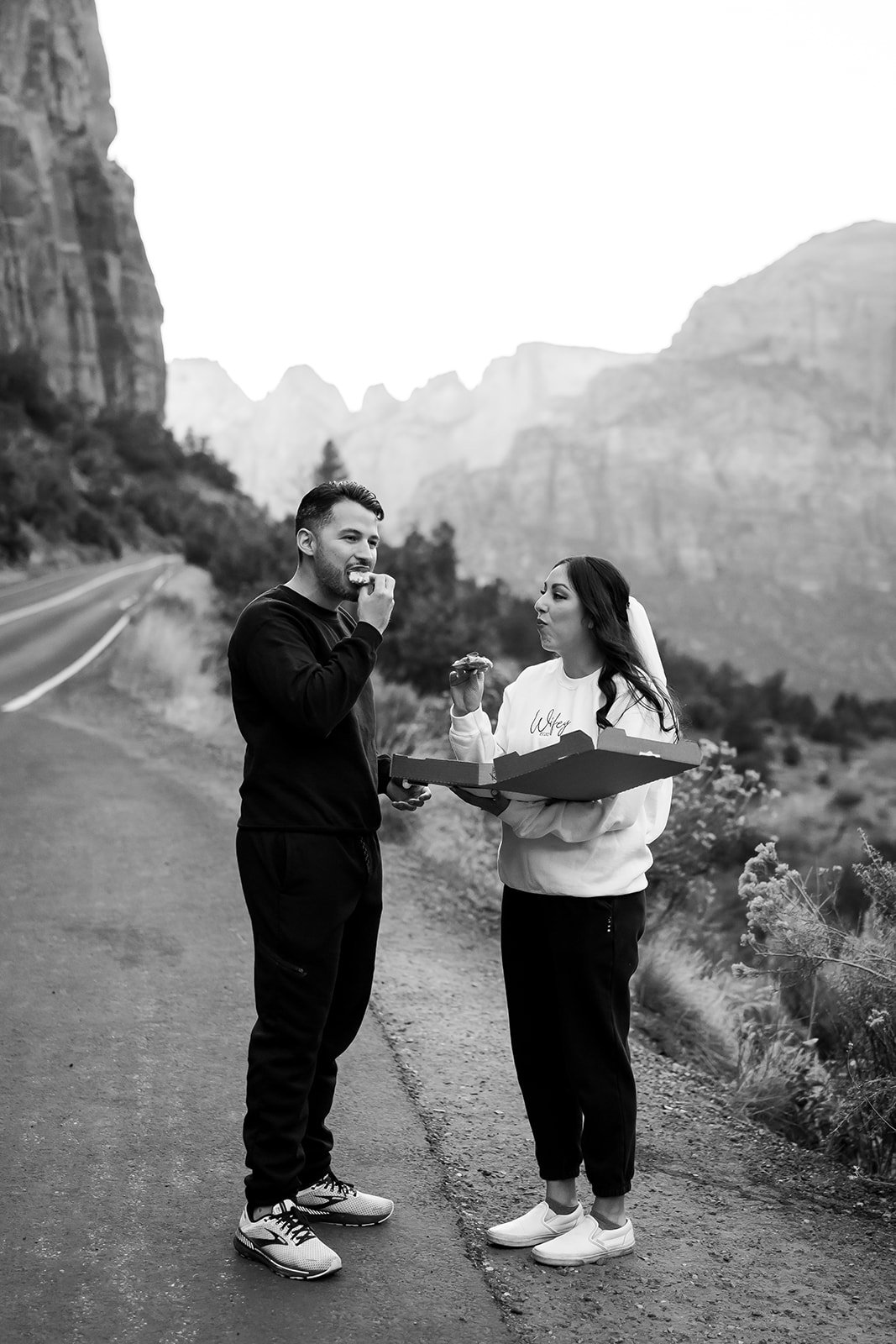  Bride and Groom sharing a pizza during their photoshoot 