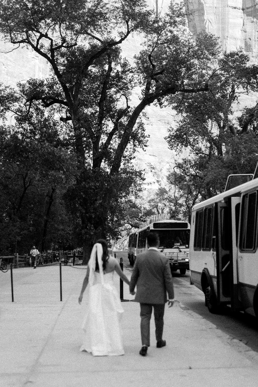  Bride and groom walking toward the shuttle bus 