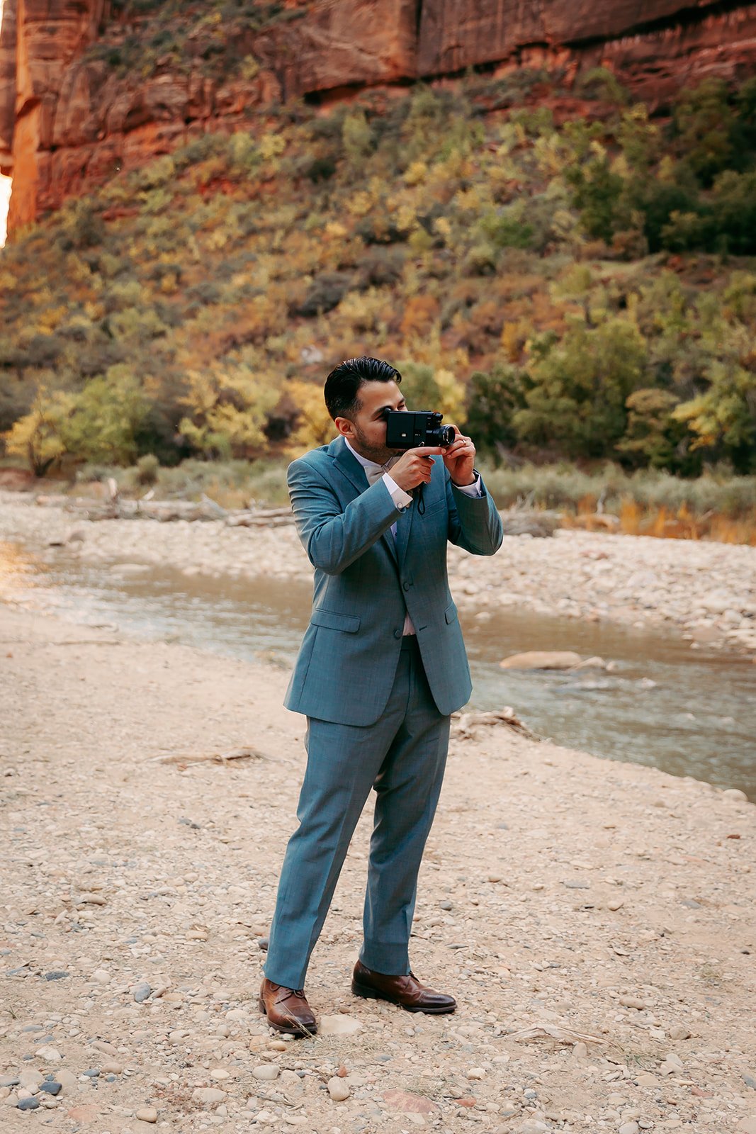  The groom films the bride with a film camera 