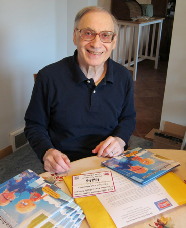  PPSN Survivor Joe Randig prepares gifts for the libraries in his county. 