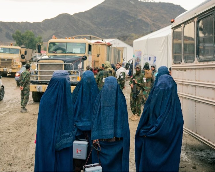 A team of polio vaccinators await arrivals at the Torkham border crossing in eastern Afghanistan on Nov. 9. (Elise Blanchard for The Washington Post)