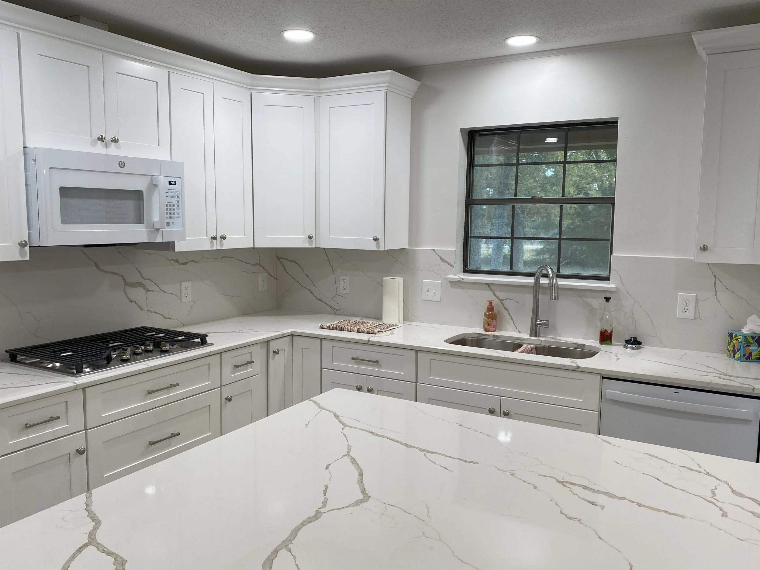 College Station LIG Kitchen Remodel Cararra quartz countertops, white tall cabinets, quartz backsplash 2.jpg