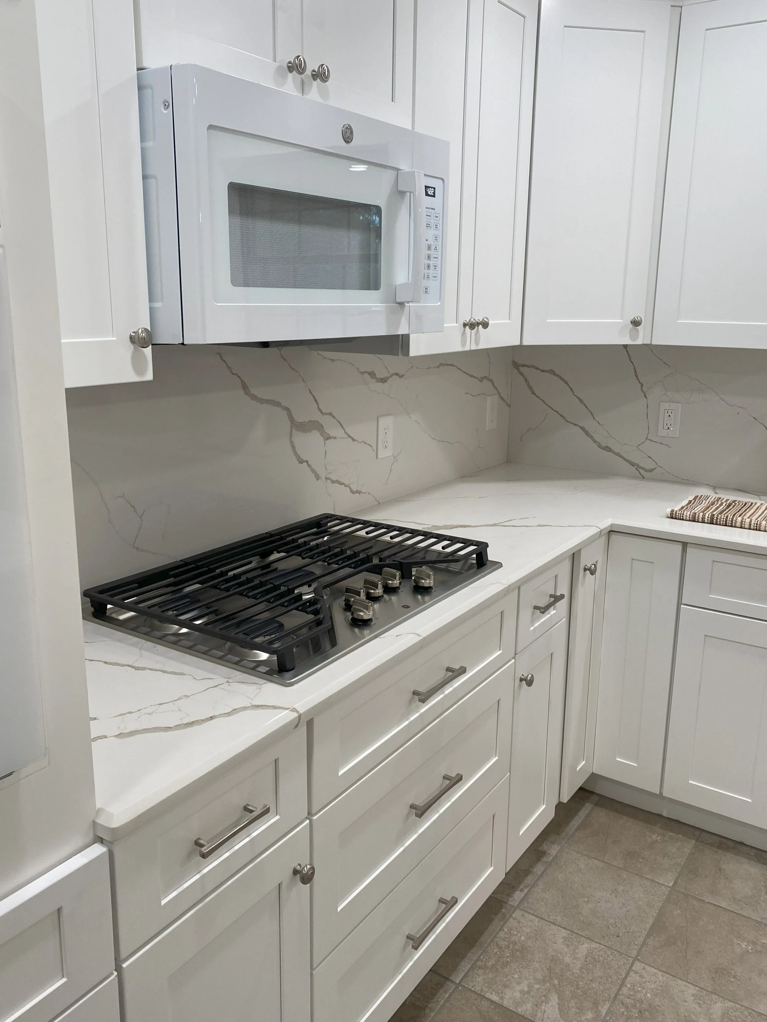 College Station LIG Kitchen Remodel Cararra quartz countertops, white tall cabinets, quartz backsplash 3.jpg