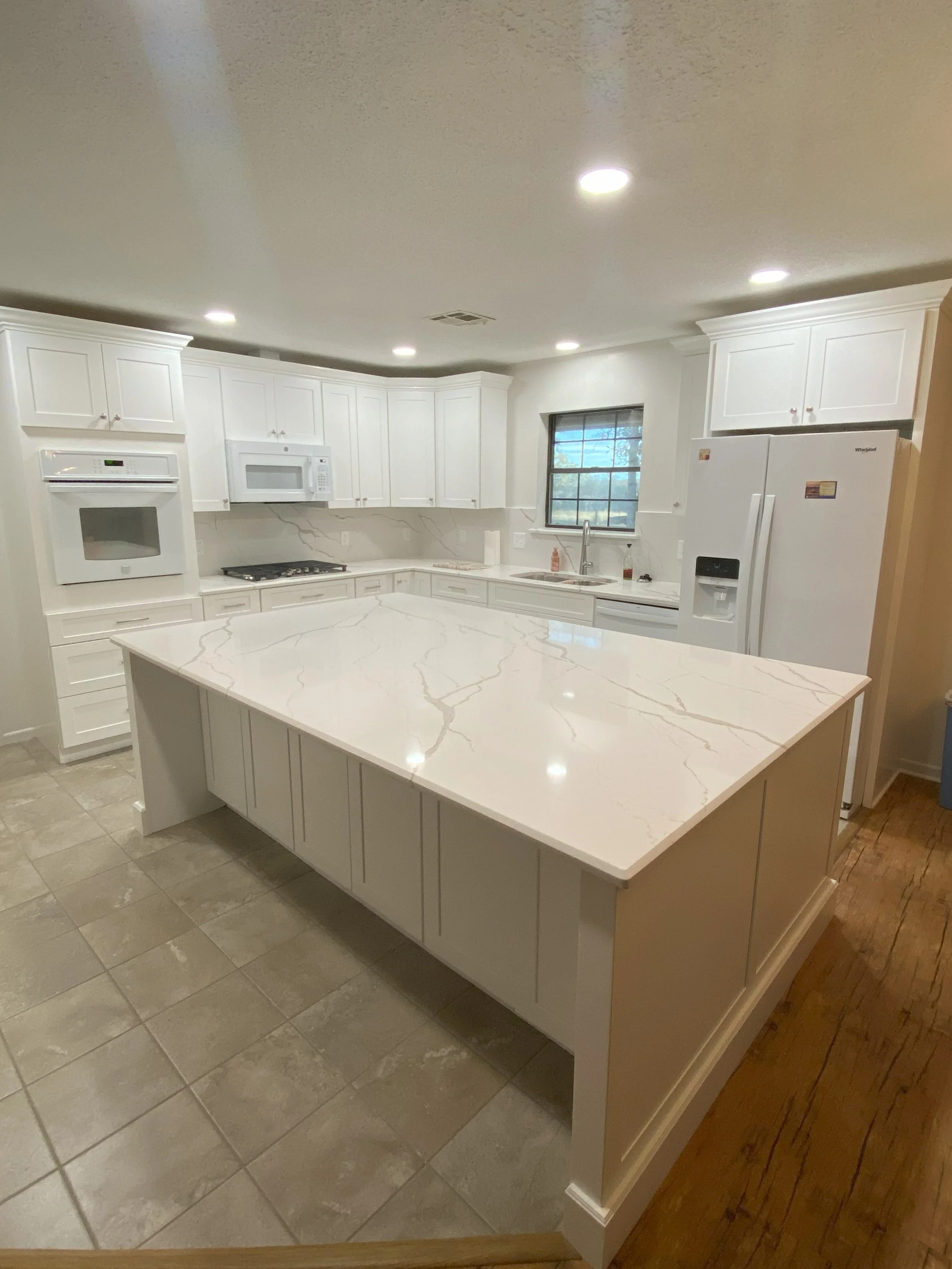 College Station LIG Kitchen Remodel Cararra quartz countertops, white tall cabinets, quartz backsplash 7.jpg