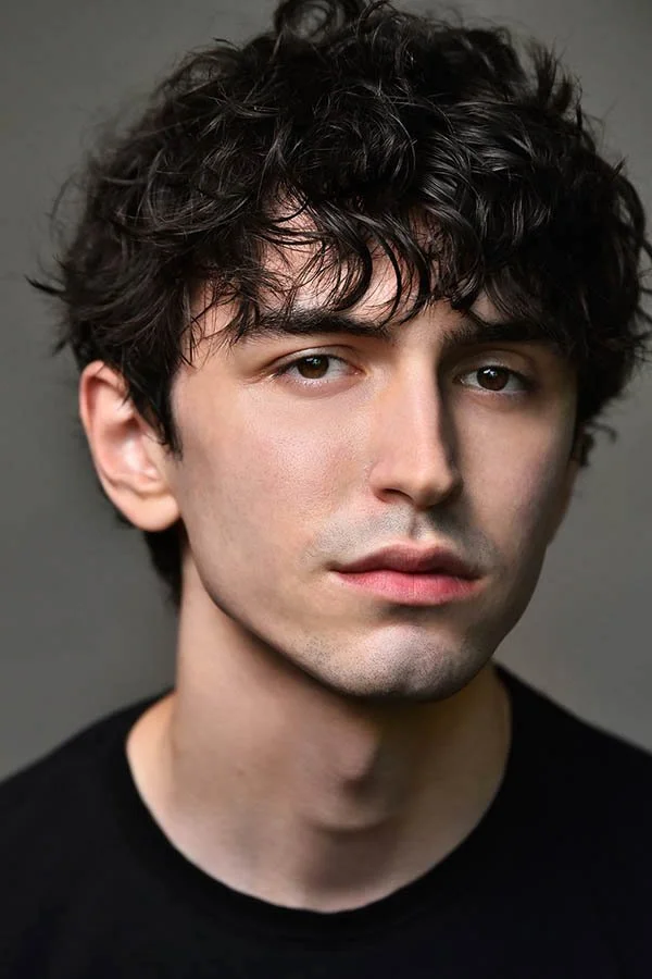 Editorial theatrical headshot of male actor with dark curly hair by Marc Cartwright, Los Angeles headshot photographer